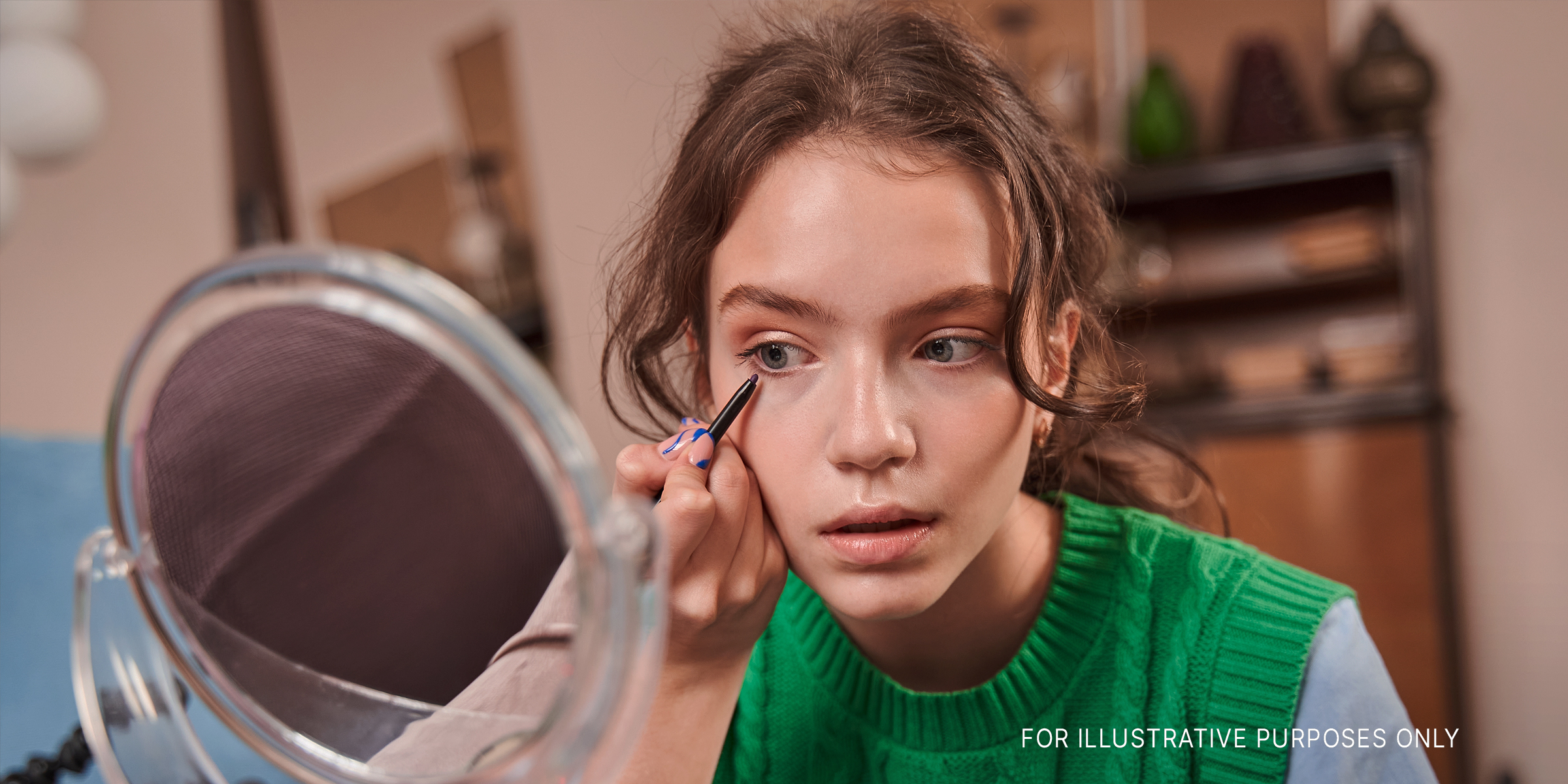 A teenage girl applying makeup | Source: Shutterstock