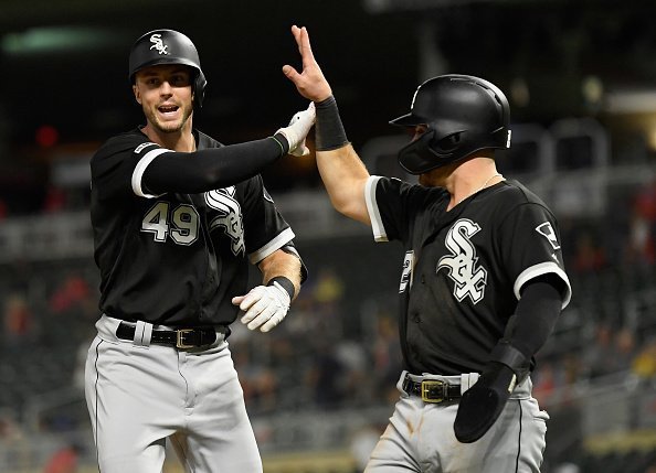 Two Chicago White Sox teammates congratulating each other during a match against the Minnesota Twins | Photo: Getty Images