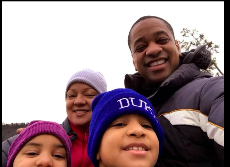 Justin, Cerina, Cameron and Carys Fairfax smile together in a close-up outdoor selfie. | Source: Facebook/JustinFairfax