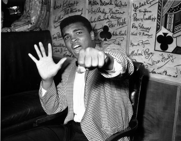  Supremely confident American boxer Cassius Clay holds up five fingers in a prediction of how many rounds it will take him to knock out British boxer Henry Cooper | Source: Getty Images