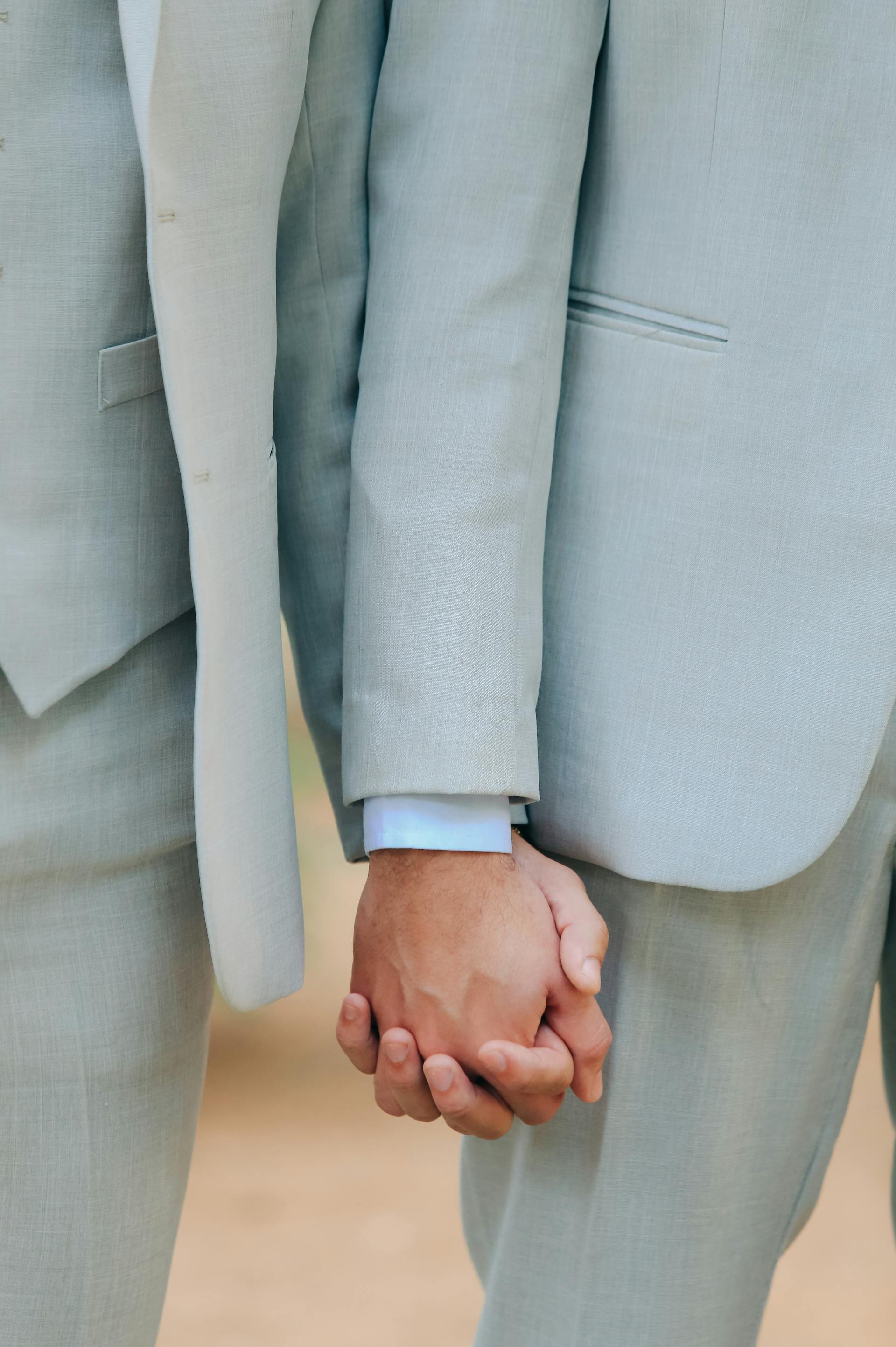 A gay couple holding hands | Source: Pexels