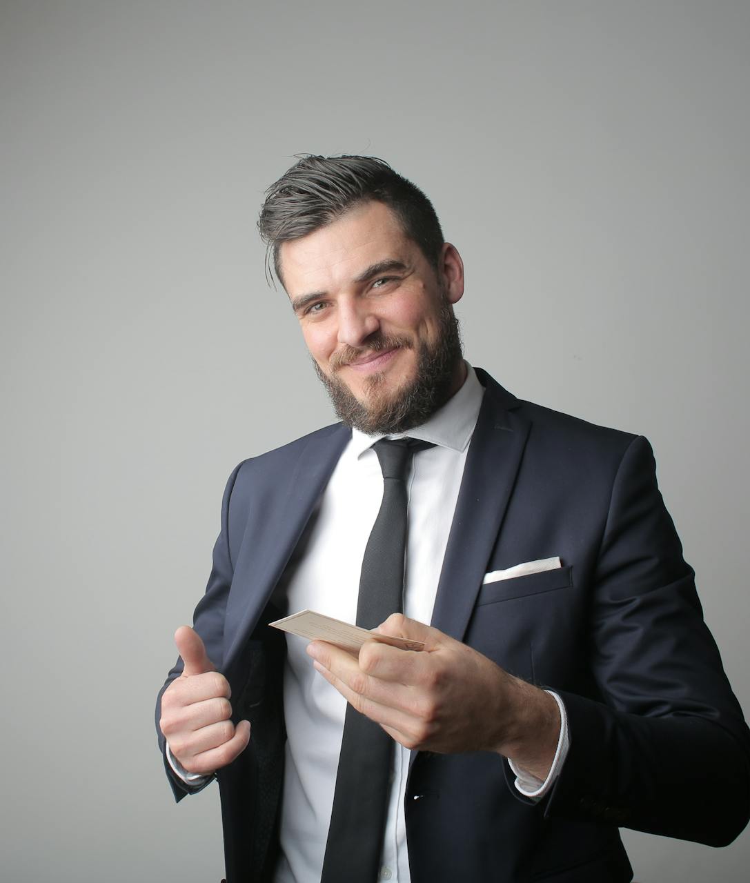 A man removing a card from his jacket pocket | Source: Pexels