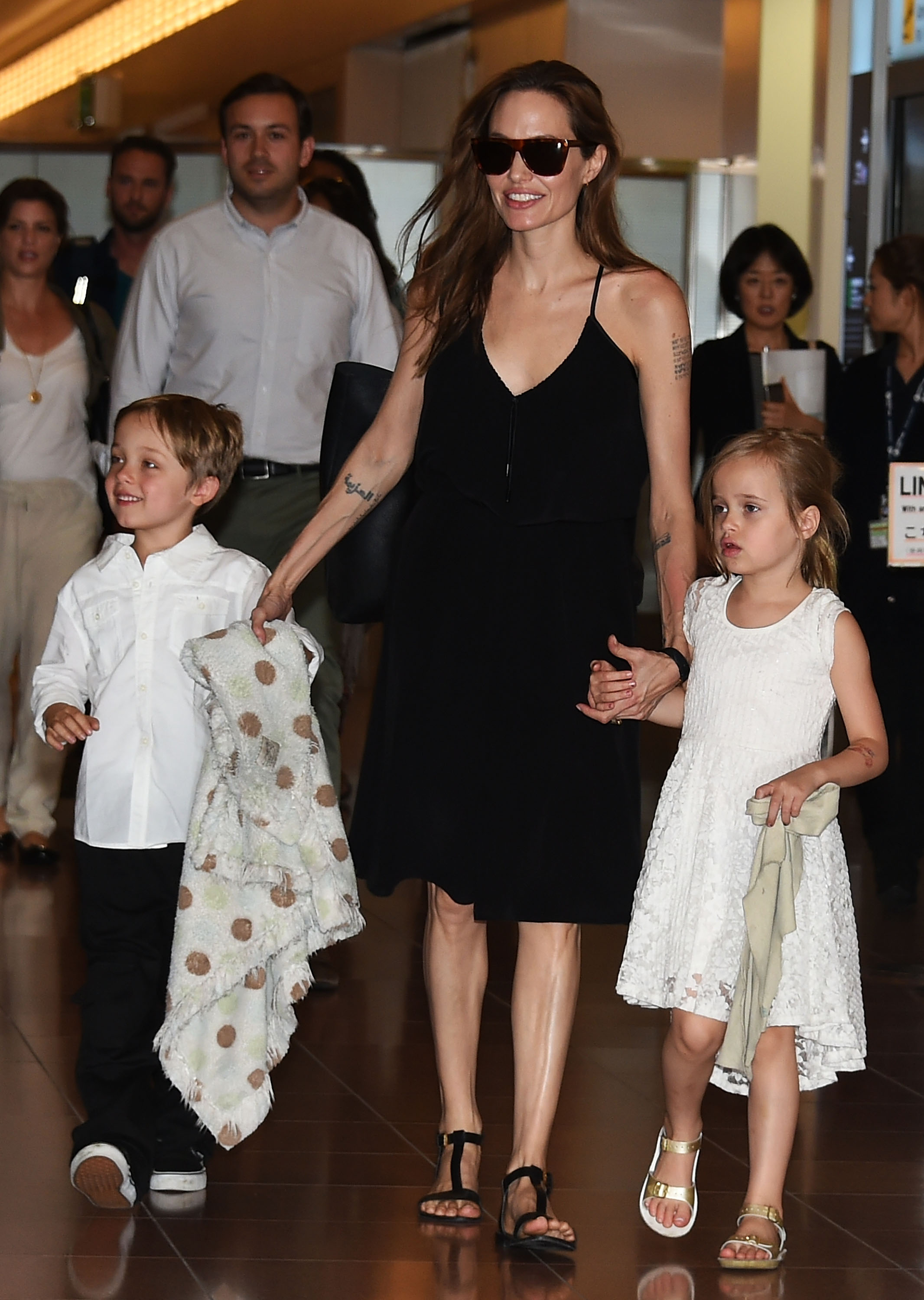 Knox Jolie-Pitt with his mother and twin sister at Haneda Airport on June 21, 2014 in Tokyo, Japan. | Source: Getty Images