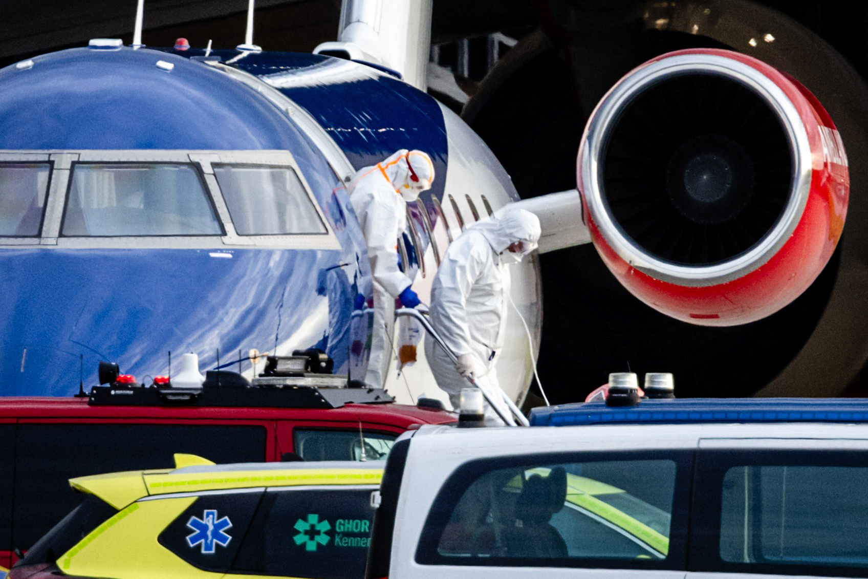 Two people in hazmat suits descending from a Bombardier Challenger 605 medical plane allegedly carrying some of the passengers from the cruise ship MV Hondius believed to be infected with hantavirus on May 6, 2026 | Source: Getty Images