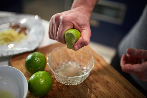 A man squeezing a lemon. | Source: Shutterstock.