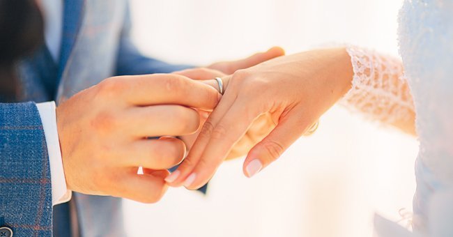 Wedding rings on a bride and groom. | Source: Shutterstock