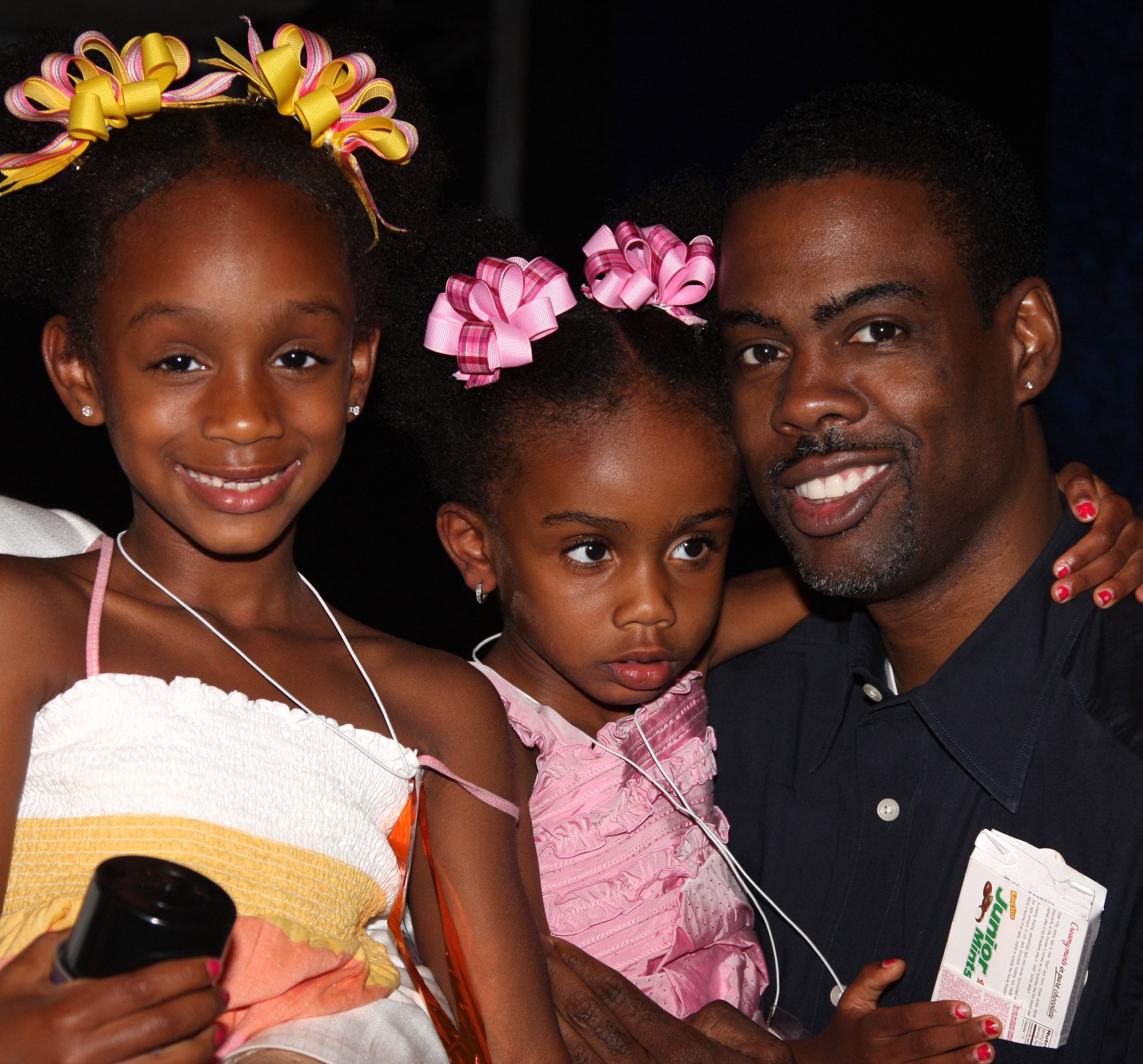 (L-R) Lola Simone Rock, Zahra Savannah Rock and Chris Rock pose at Lola's 6th birthday celebration at "Hairspray" on Broadway at the Neil Simon Theatre on June 28, 2008, in New York City | Source: Getty Images