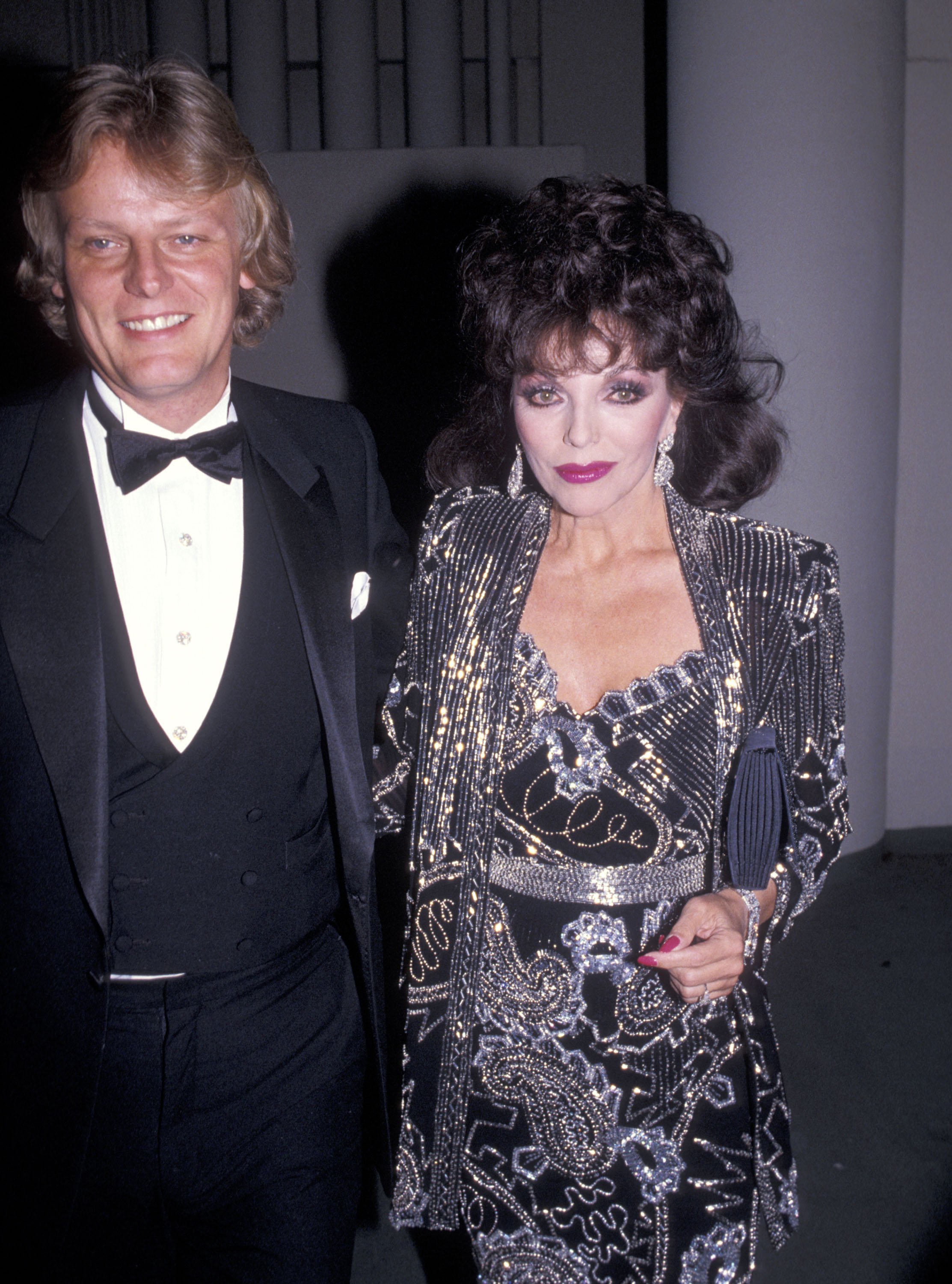 Joan Collins and her boyfriend Peter Holm during the 42nd Annual Golden Globe Awards at Beverly Hilton Hotel on January 26, 1985 in Beverly Hills, California. | Source: Getty Images