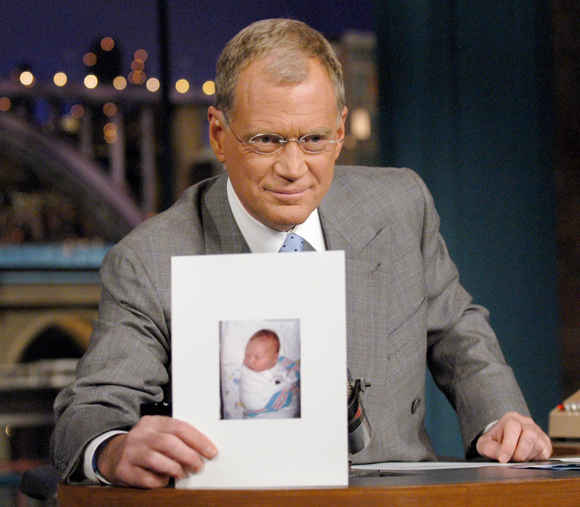 David Letterman holds a photo of his new son, Harry Joseph Letterman, on "The Late Show with David Letterman" on November 4, 2003 on the CBS Television Network I Source: Getty Images 