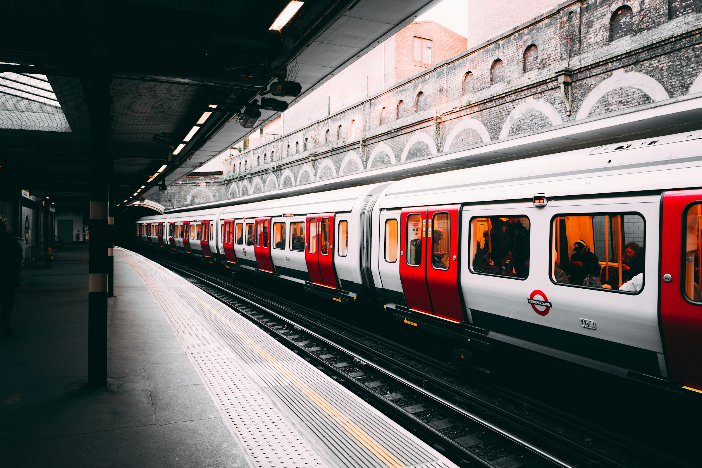 A white and red train moving on a railway track | Source: Unsplash