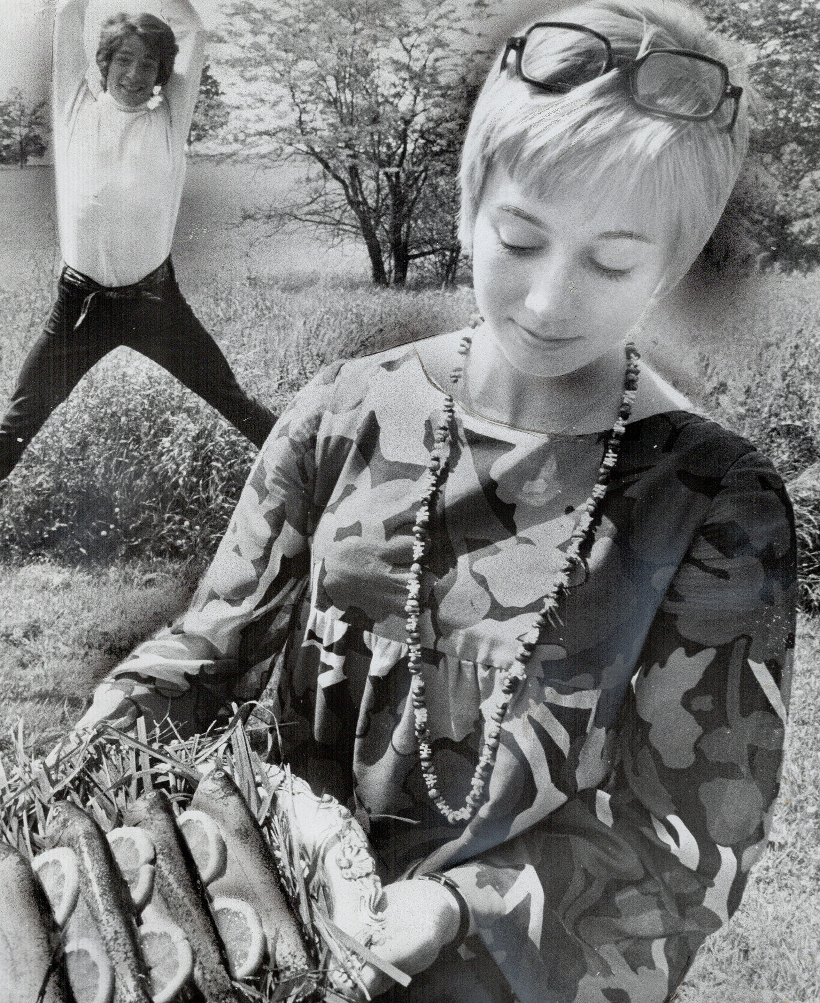 Sandy Duncan holding a plate of trout with Jon Stevens in the background in 1968, in Canada | Source: Getty Images