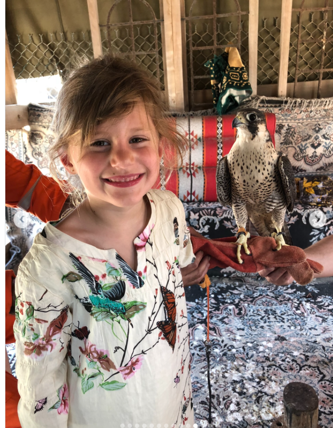 A young Vivian Brady holds a bird, as seen from a post dated December 5, 2025. | Source: Instagram/tombrady