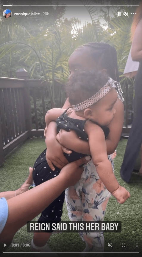 A screenshot from a clip of Toya Johnson's 3-year-old daughter Reign holding Zonnique Pullins' child, Hunter Zoelle James | Photo: Instagram.com/zonniquejailee