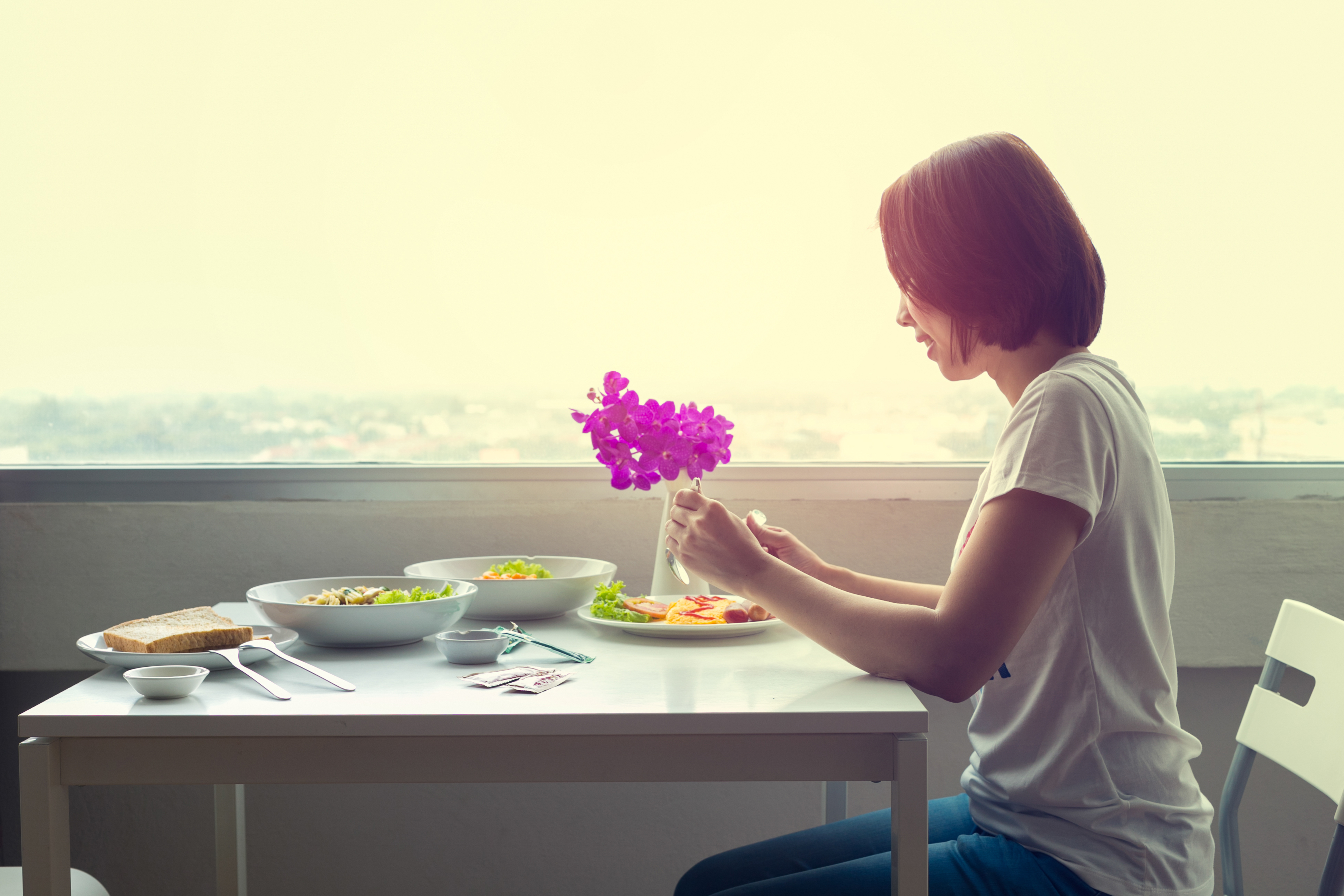 A woman eating a restaurant dinner alone | Source: Shutterstock