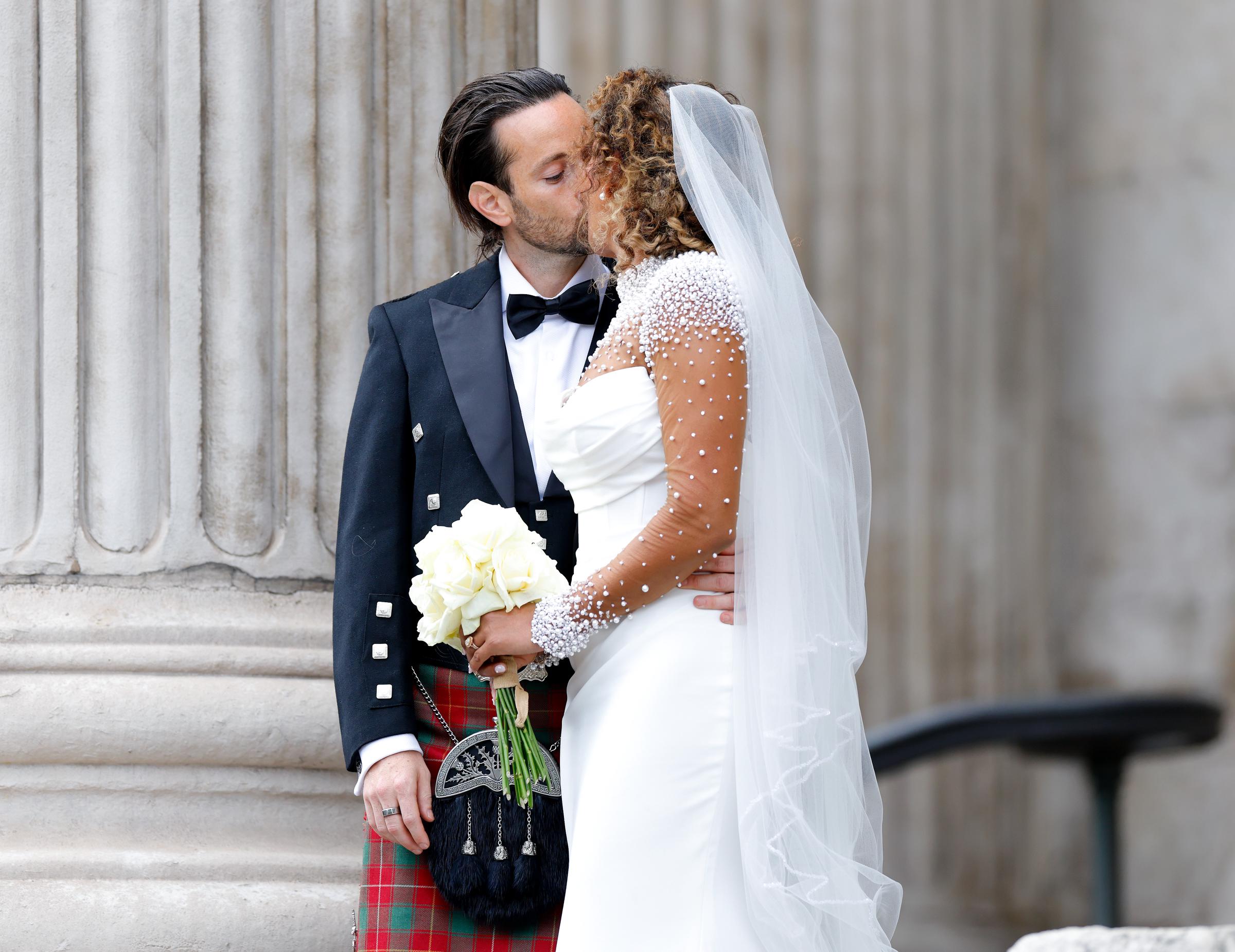 Melanie Brown and her husband Rory McPhee share a kiss as they depart following their wedding at St Paul's Cathedral, London on July 5, 2025 | Source: Getty Images