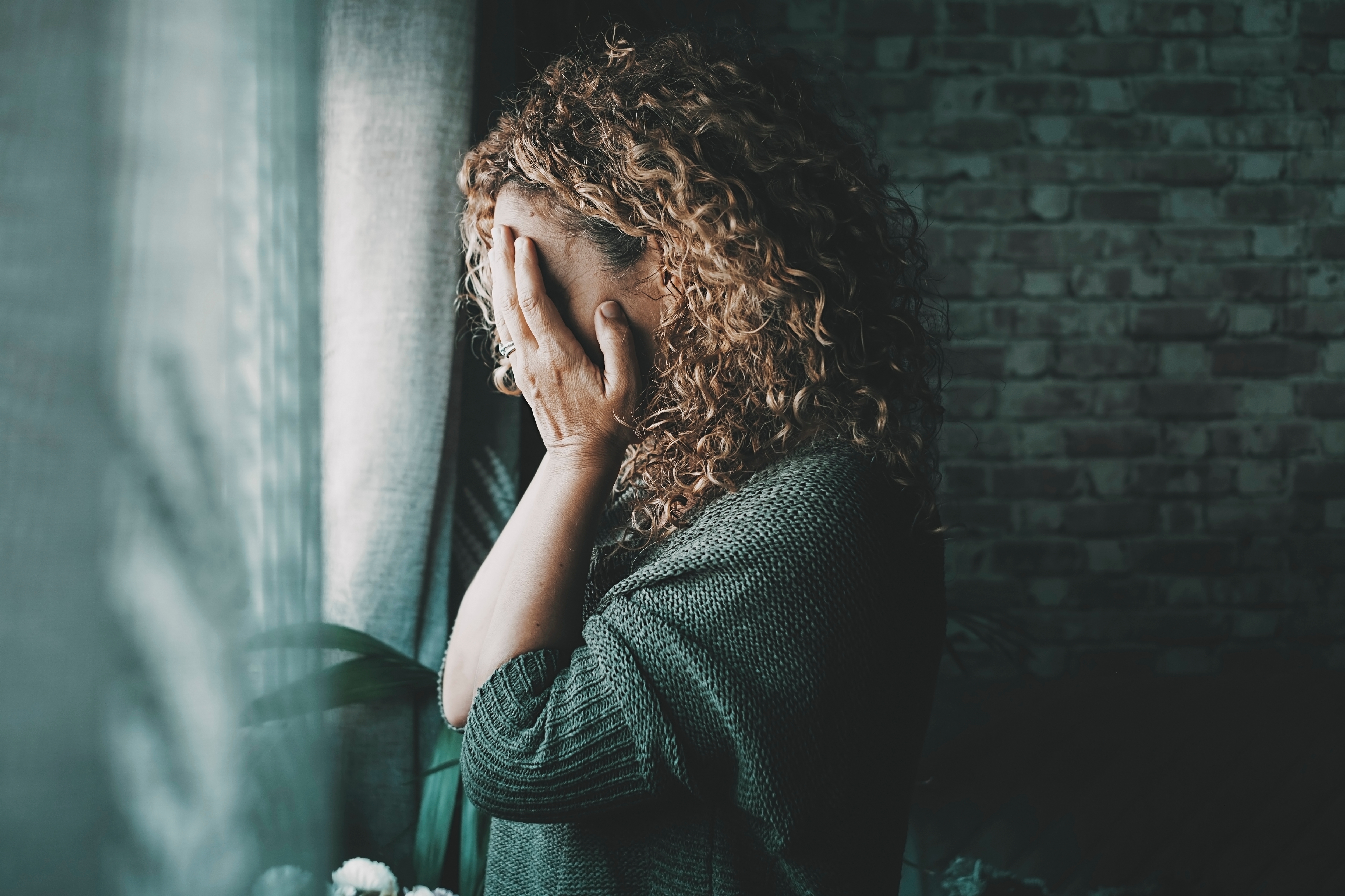 Sad and worried woman side portrait. | Source: Shutterstock