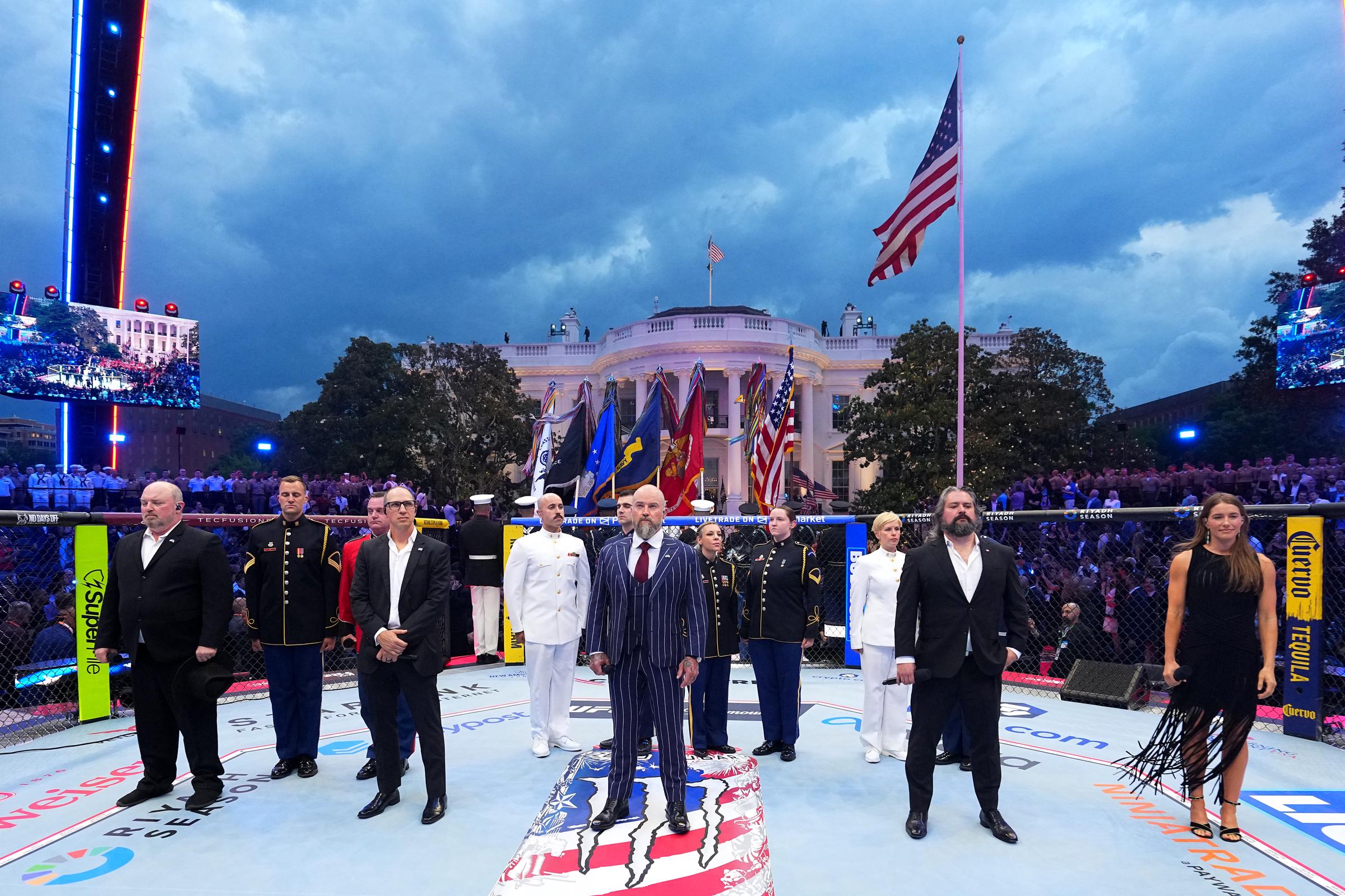 Members of the Zac Brown Band and the United States Marine Band take part in a ceremonial presentation inside the UFC Freedom 250 octagon on the White House South Lawn. | Source: Getty Images