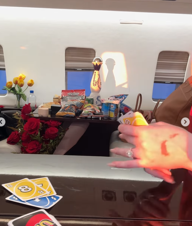 Inside the private jet, snacks fill the table as Winnie Harlow plays cards | Source: Instagram/winnieharlow