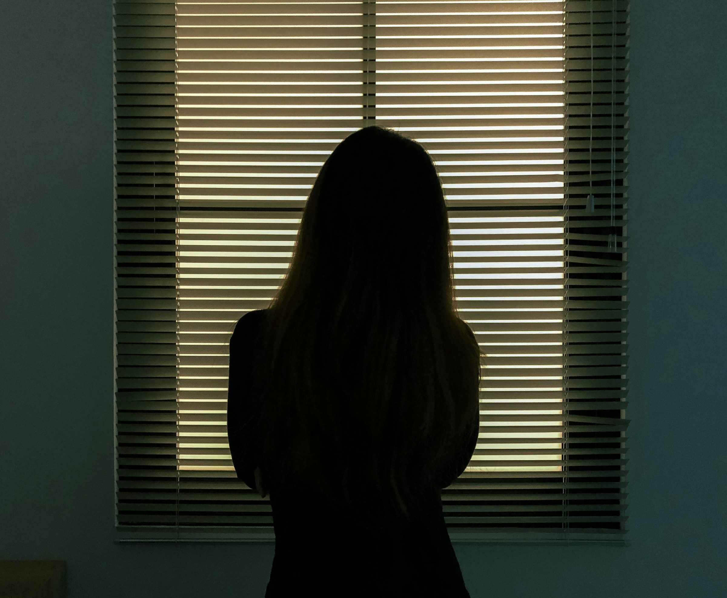 A woman looking out a window | Source: Unsplash