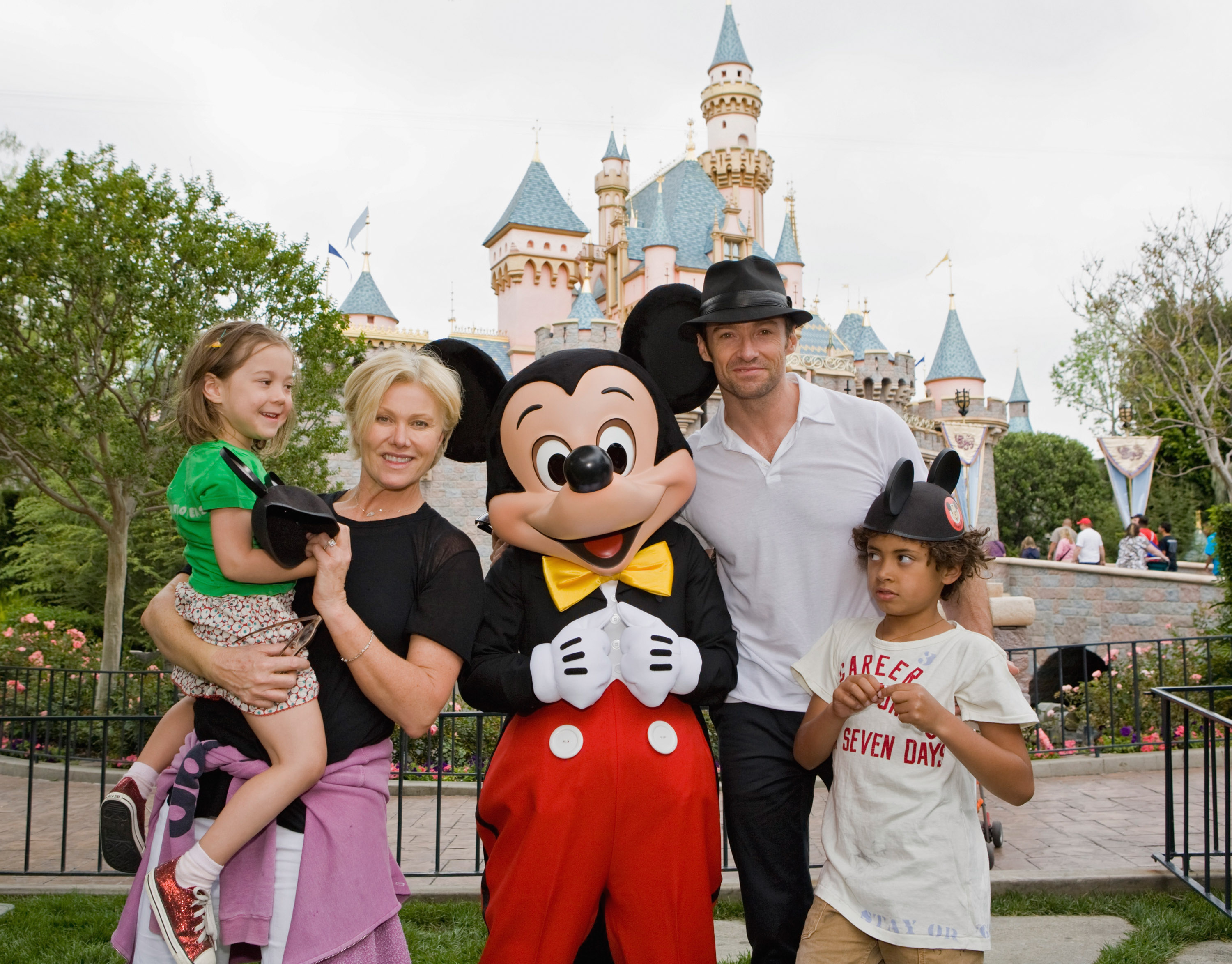 Actor Hugh Jackman, his now ex-wife Deborra Lee Furness, and children Oscar Jackman and, Ava Jackman pose with Mickey Mouse outside Sleeping Beauty Castle at Disneyland on April 23, 2009, in Anaheim, California | Source: Getty Images