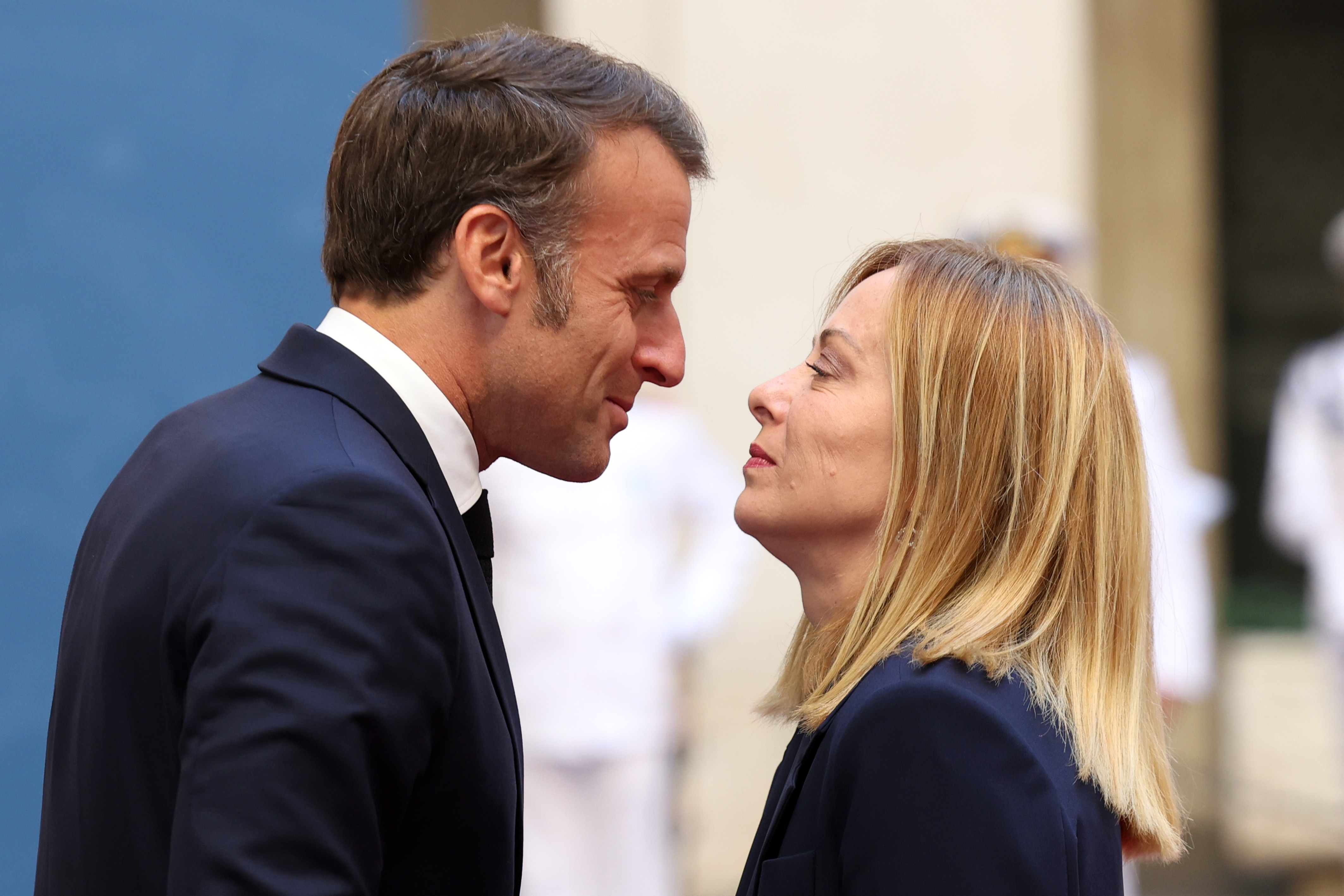 Emmanuel Macron and Giorgia Meloni are seen in a close face-to-face greeting at Palazzo Chigi on June 3, 2025. The French president leans in with a slight smile as Meloni meets his gaze, creating a moment that drew public attention.