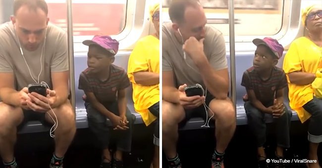 Subway passenger lets adorable boy play games on his phone