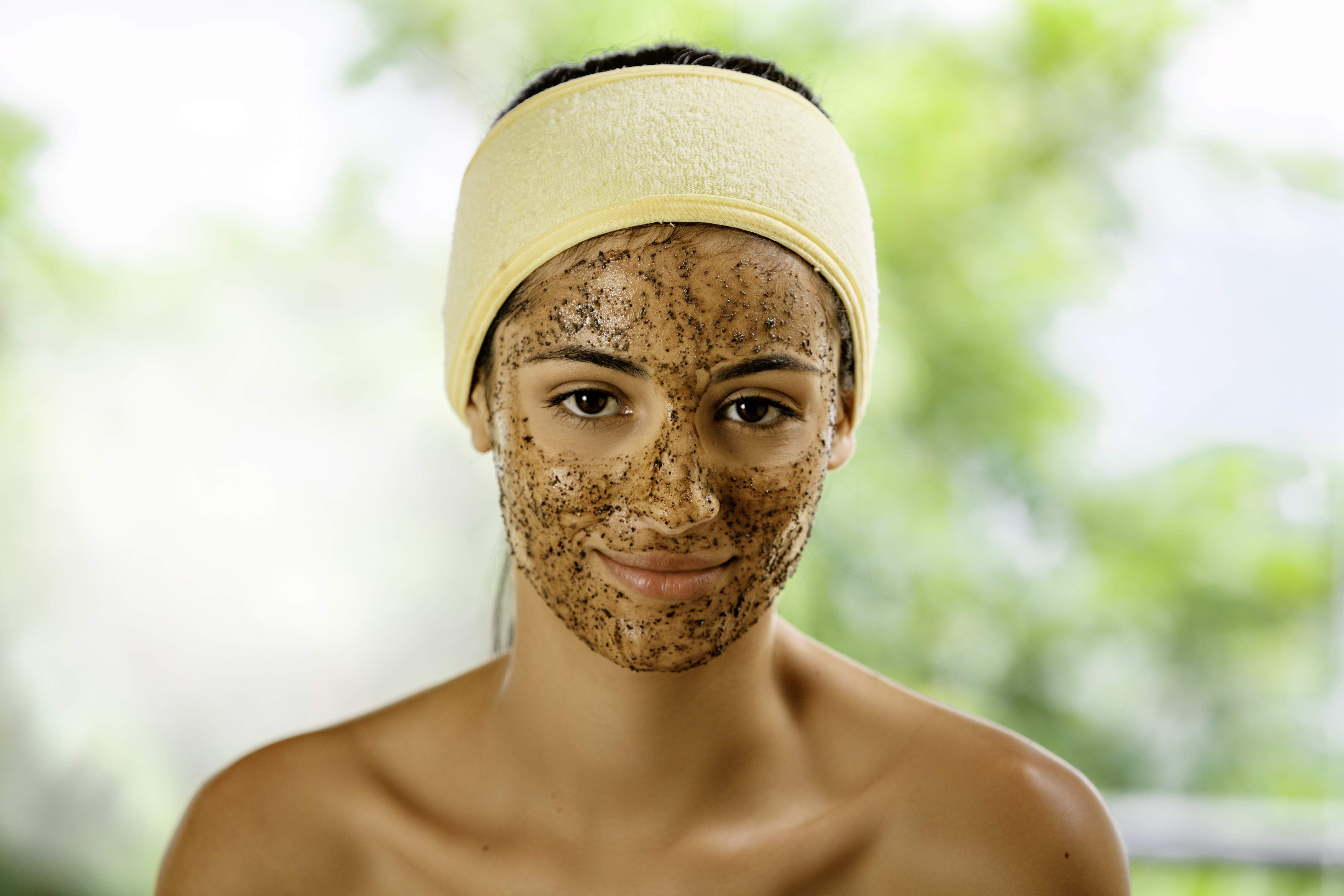 A woman exfoliating her face | Source: Getty Images