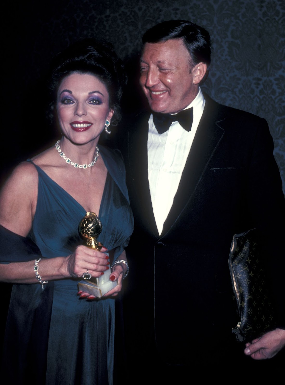 On January 30, 1982, Joan Collins attended the 39th Annual Golden Globe Awards with Ronald S. Kass. A former music executive, Kass was a significant presence in her life despite the financial and personal struggles that eventually strained their marriage. | Source: Getty Images