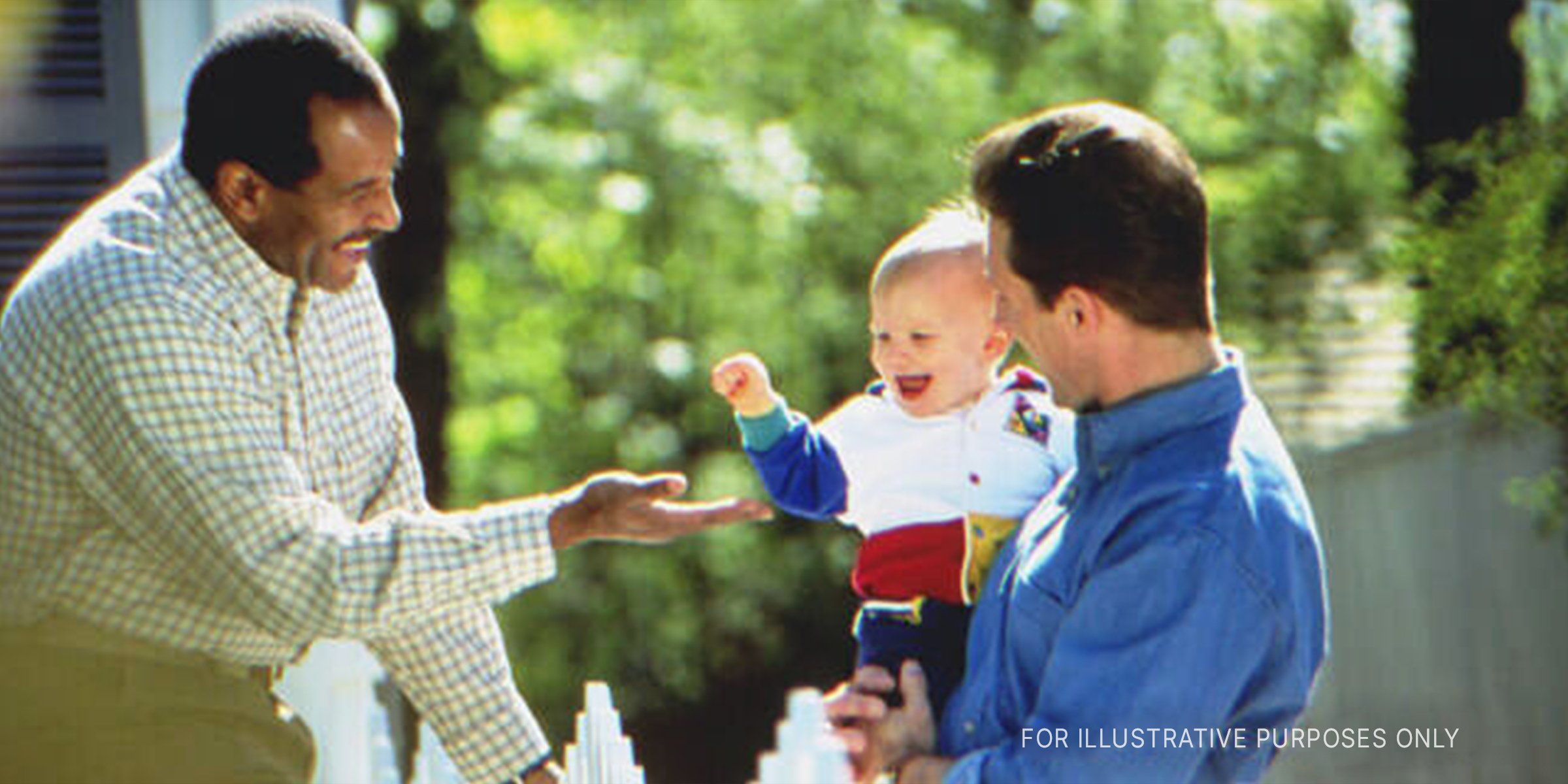 Two Men Interacting With An Adorable Baby. | Source: Getty Images