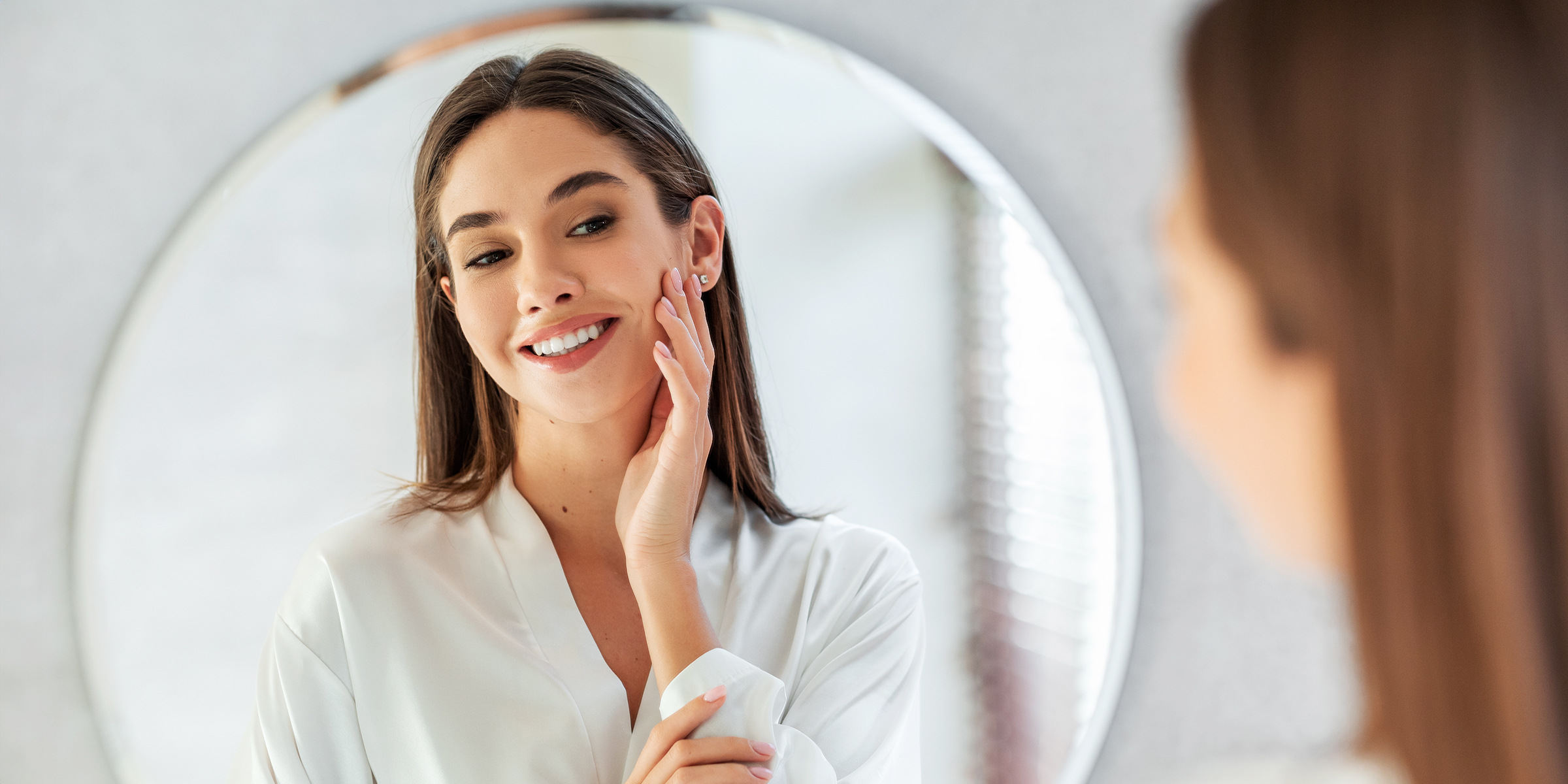 A woman looking in a mirror | Source: Shutterstock