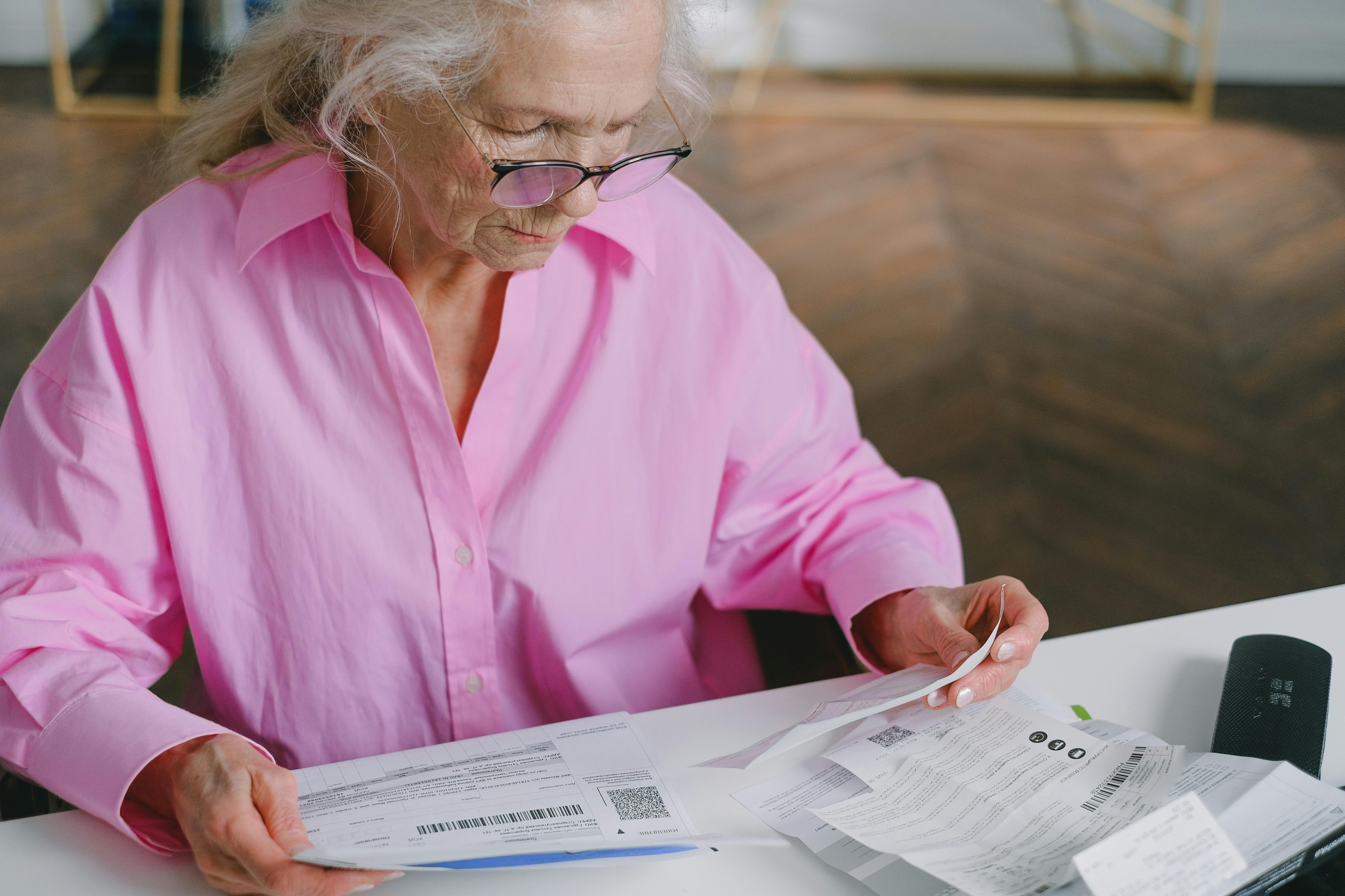 An elderly woman reading documents | Source: Pexels