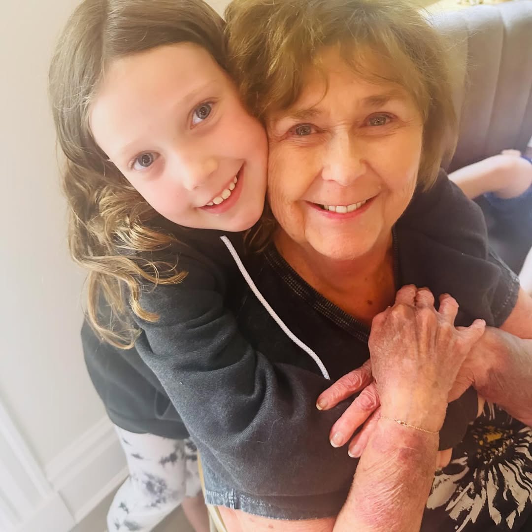 One of Nancy Guthrie's daughters hig her from behind, from a post dated May 12, 2024. | Source: Instagram/savannahguthrie