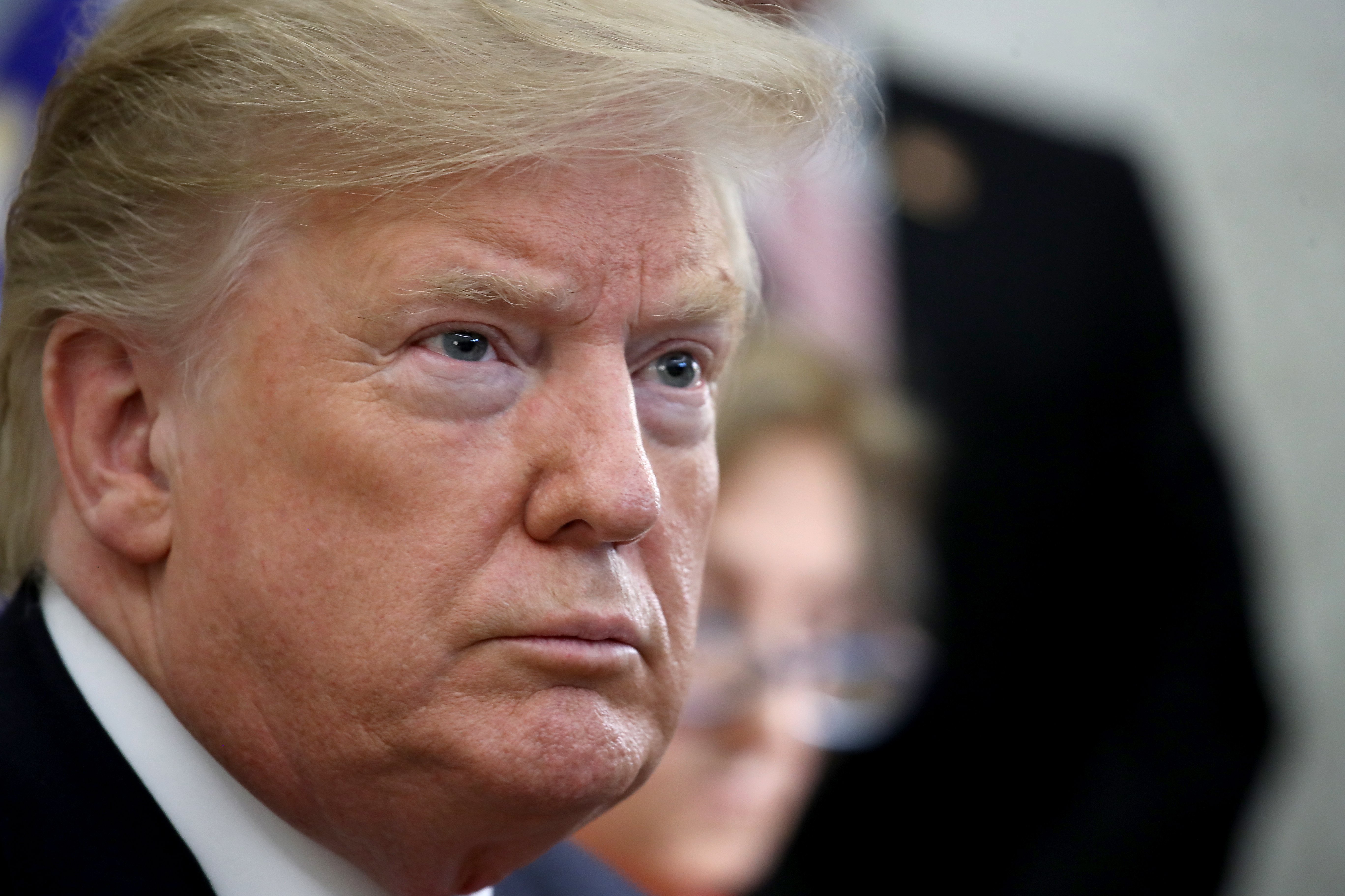 President Donald Trump listens while meeting with Fabiana Rosales, the wife of Venezuelan opposition leader Juan Guaido