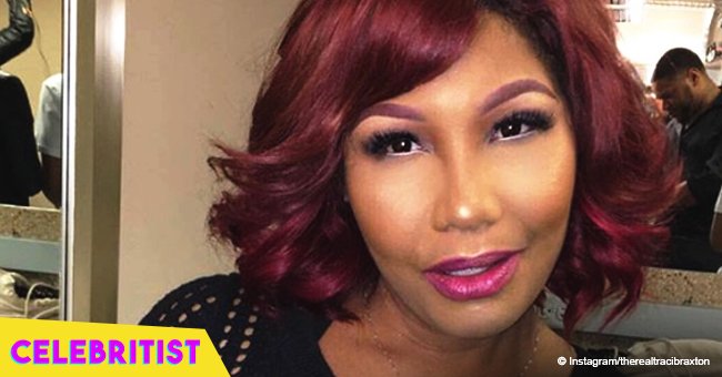 Traci Braxton stuns in black leather strapless dress with short red hairdo in new photo