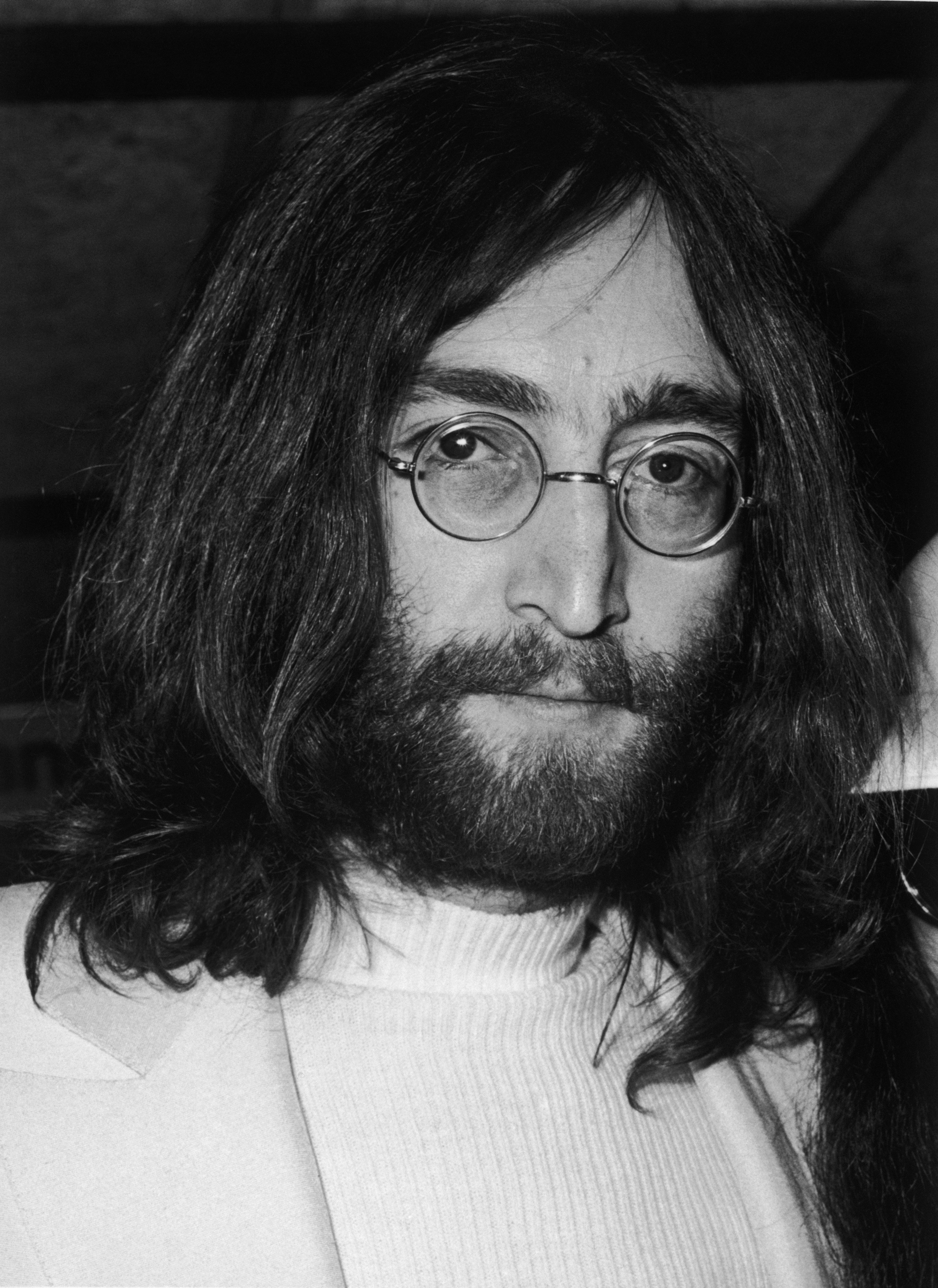 The late John Lennon Beatles, at a press conference at Heathrow airport on his return from honeymoon with Yoko Ono. | Source: Getty Images