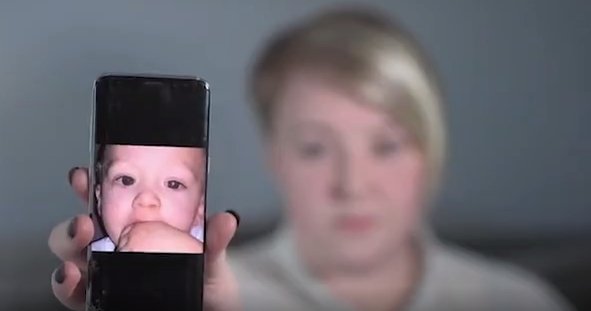 Emily Smith with the photograph on her mobile phone showing Jaxson's cancer. | Source: Videos.DailyNews
