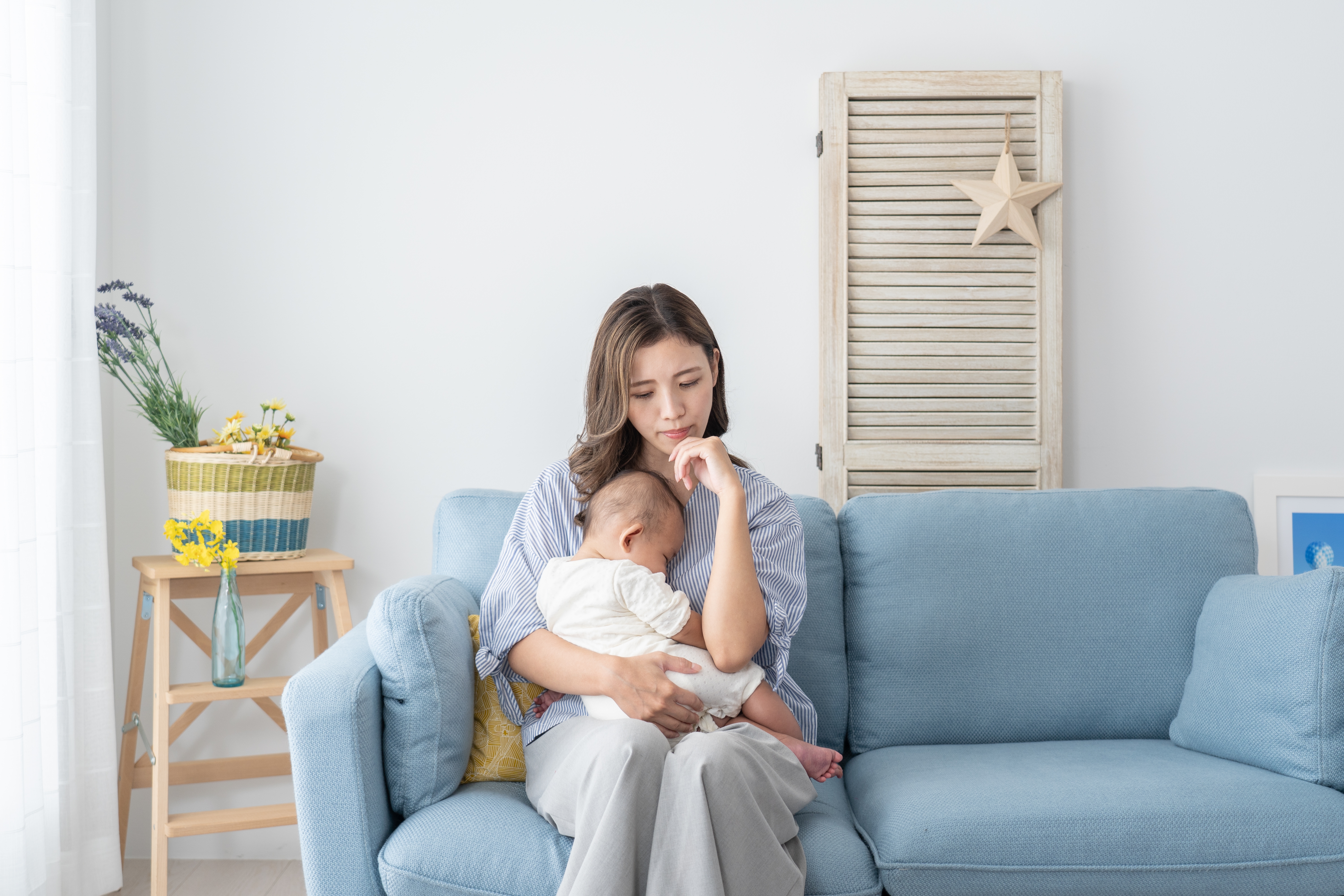 A woman sitting with a baby | Source: Shutterstock