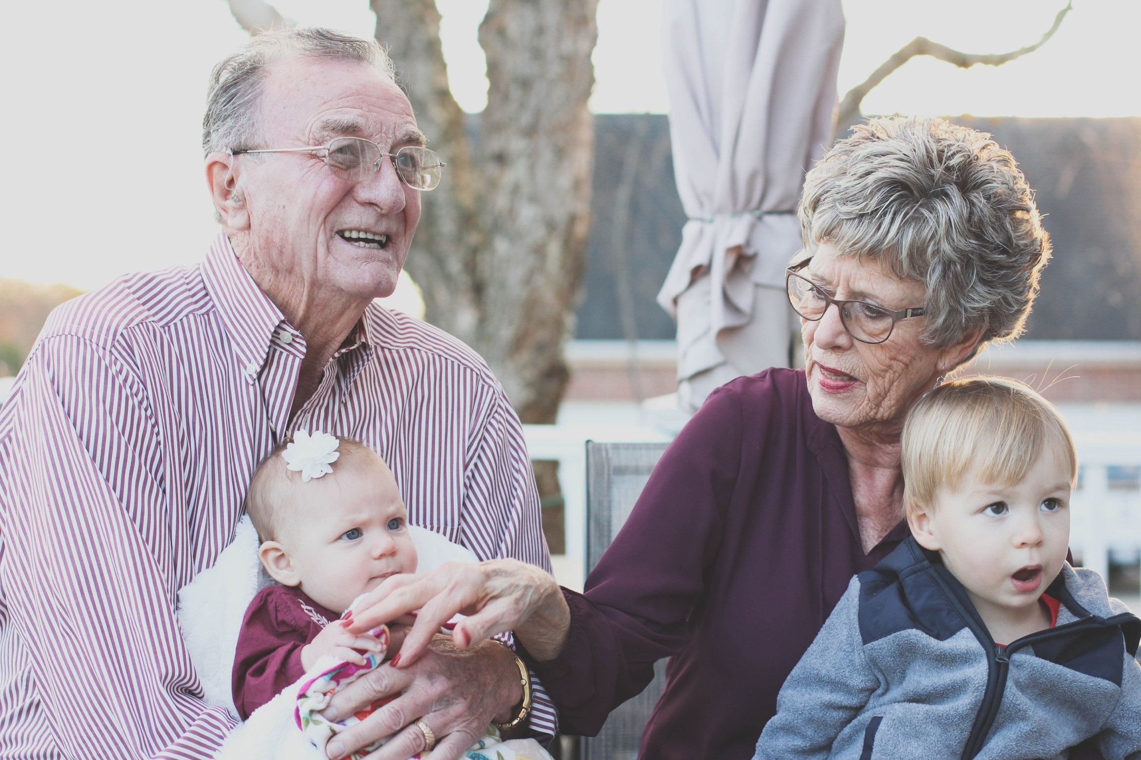 Couple with their young grandchildren | Source: Pexels