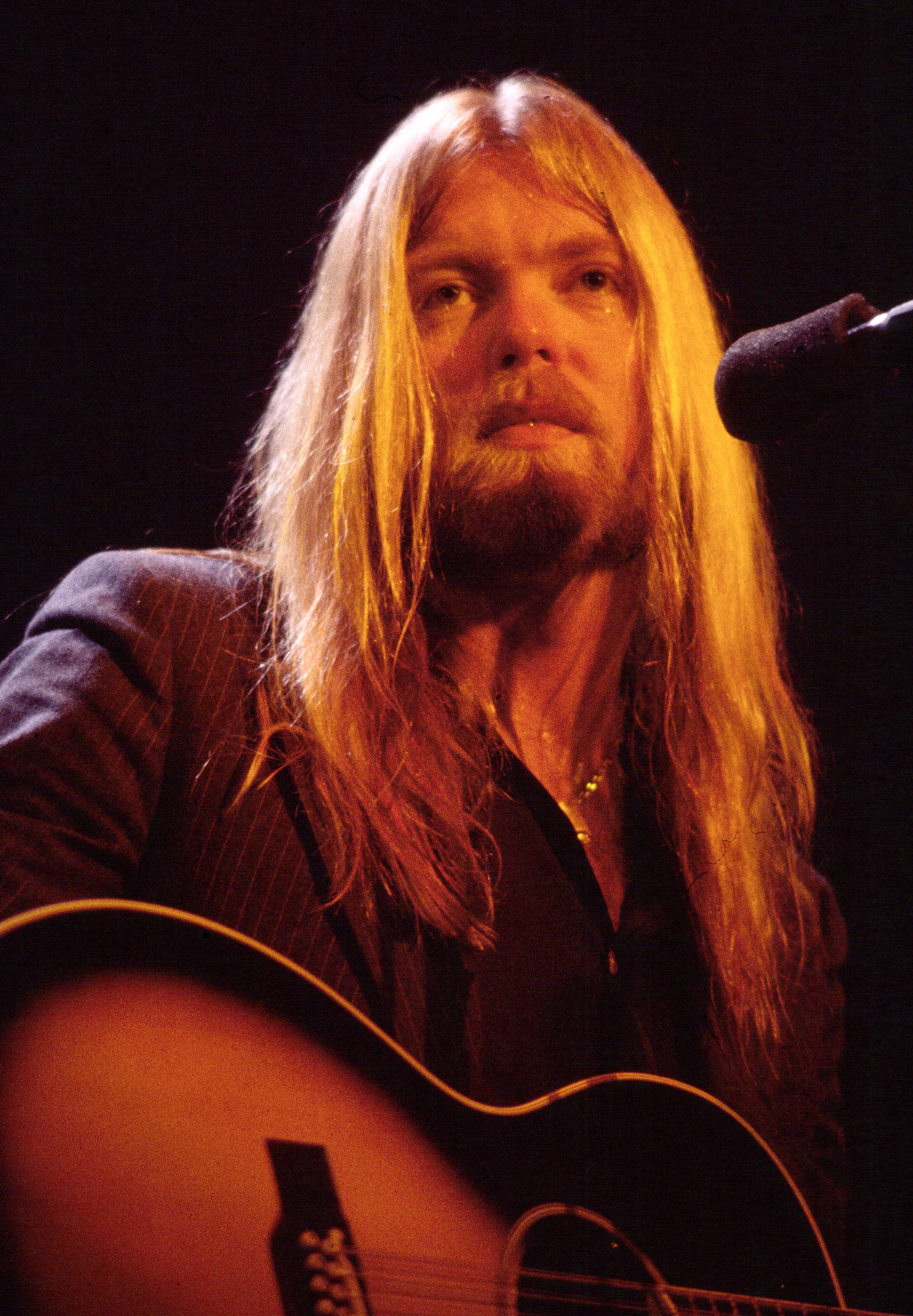 Gregg Allman plays guitar onstage at the Capitol Theatre in Passaic, New Jersey, on December 16, 1981 | Source: Getty Images