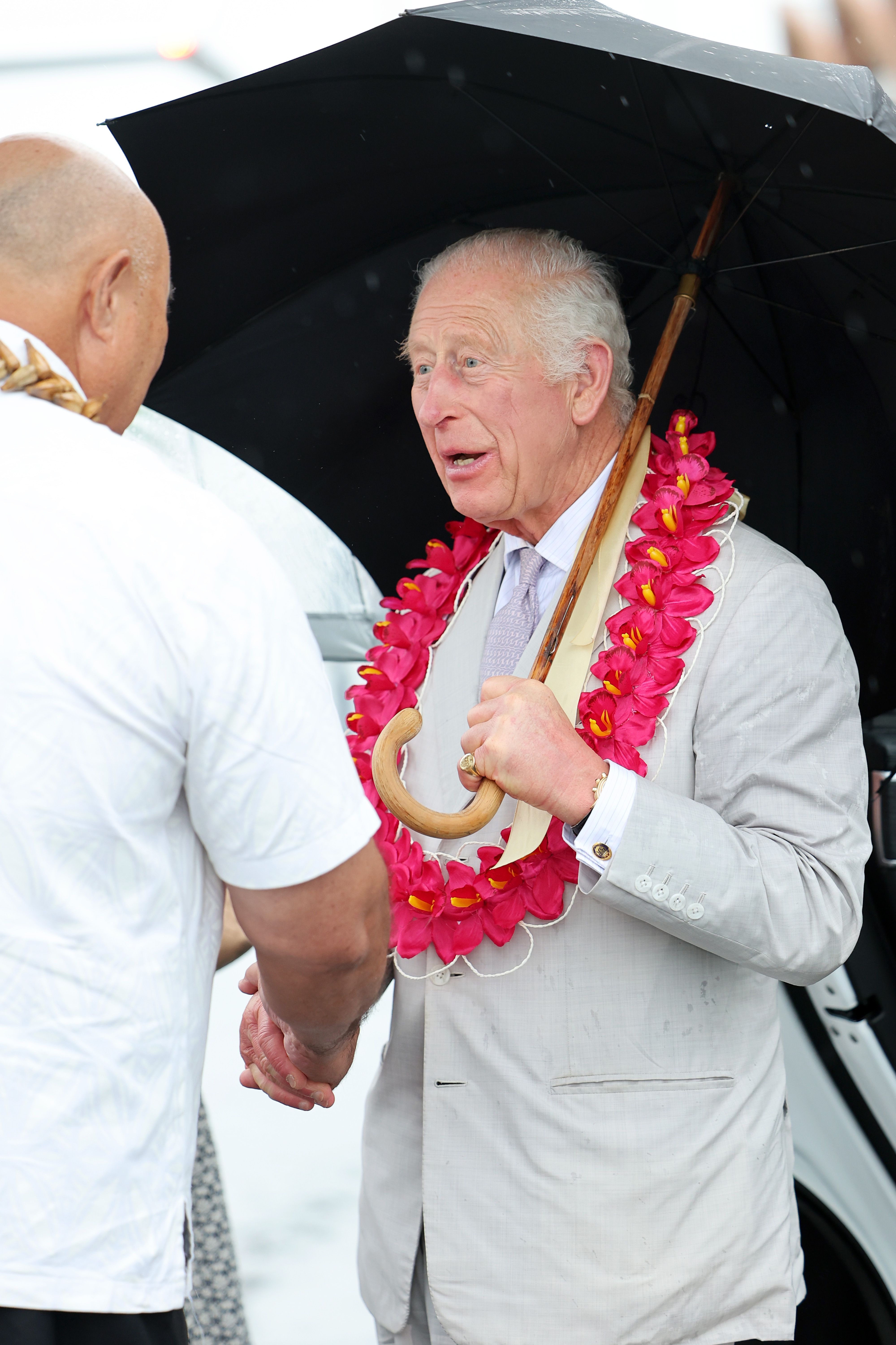 King Charles III interacting with a Samoan before boarding The Royal Australian Air Force jet after the farewell. | Source: Getty Images