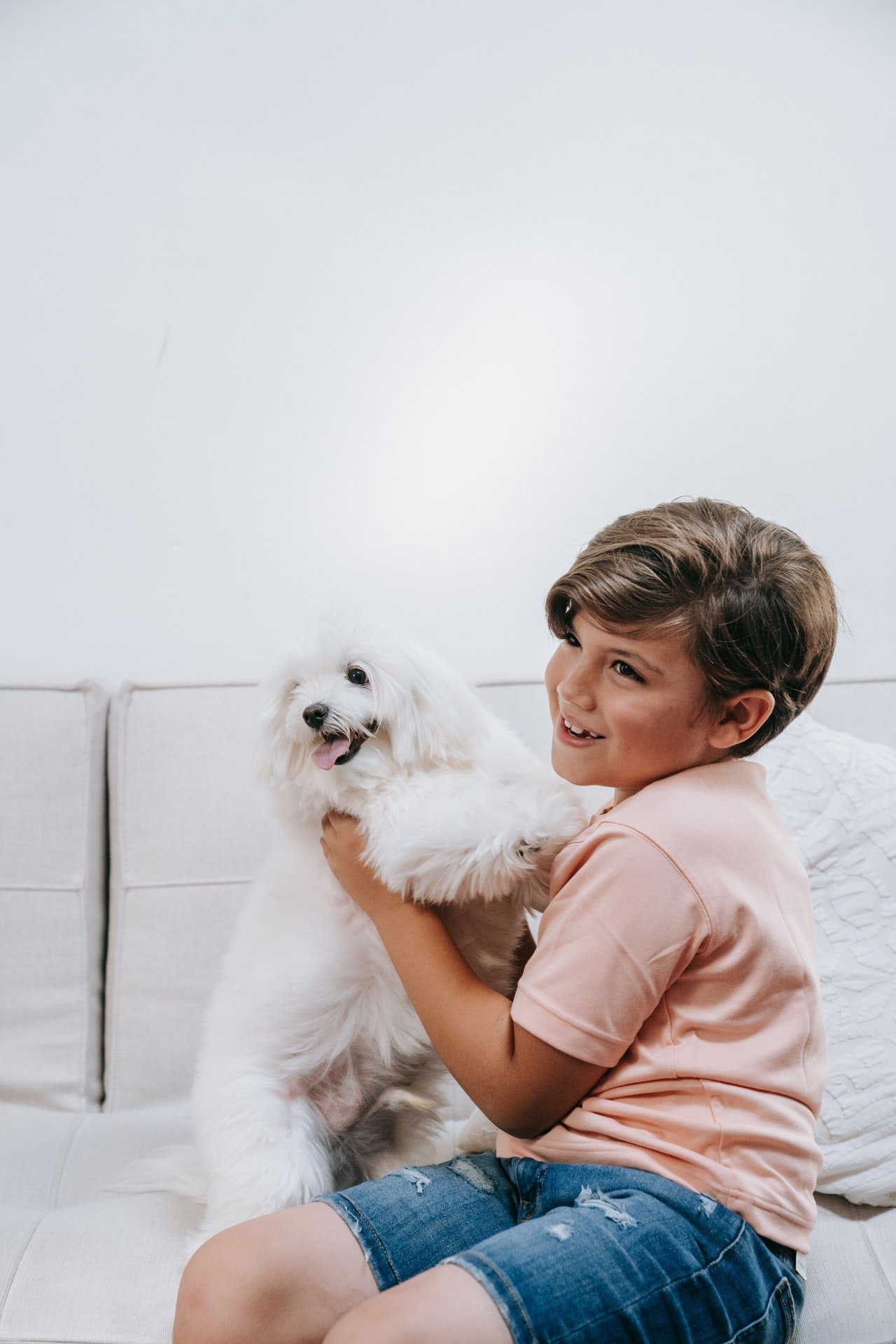 Boy sitting with a dog | Source: Pexels
