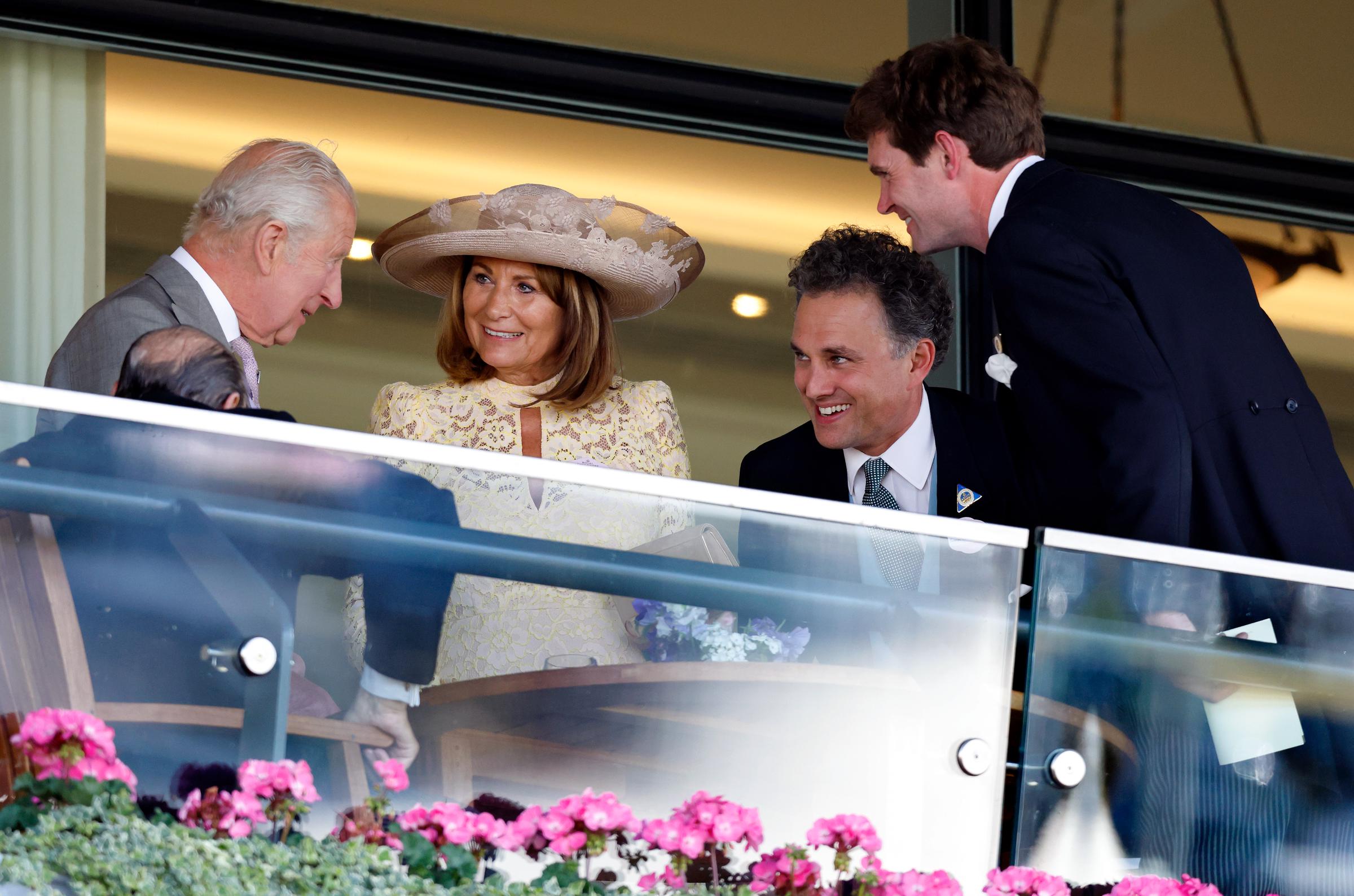King Charles III, Carole Middleton, Thomas van Straubenzee, and James Meade share a light moment in the royal box during day two of Royal Ascot on June 18, 2025, in England.