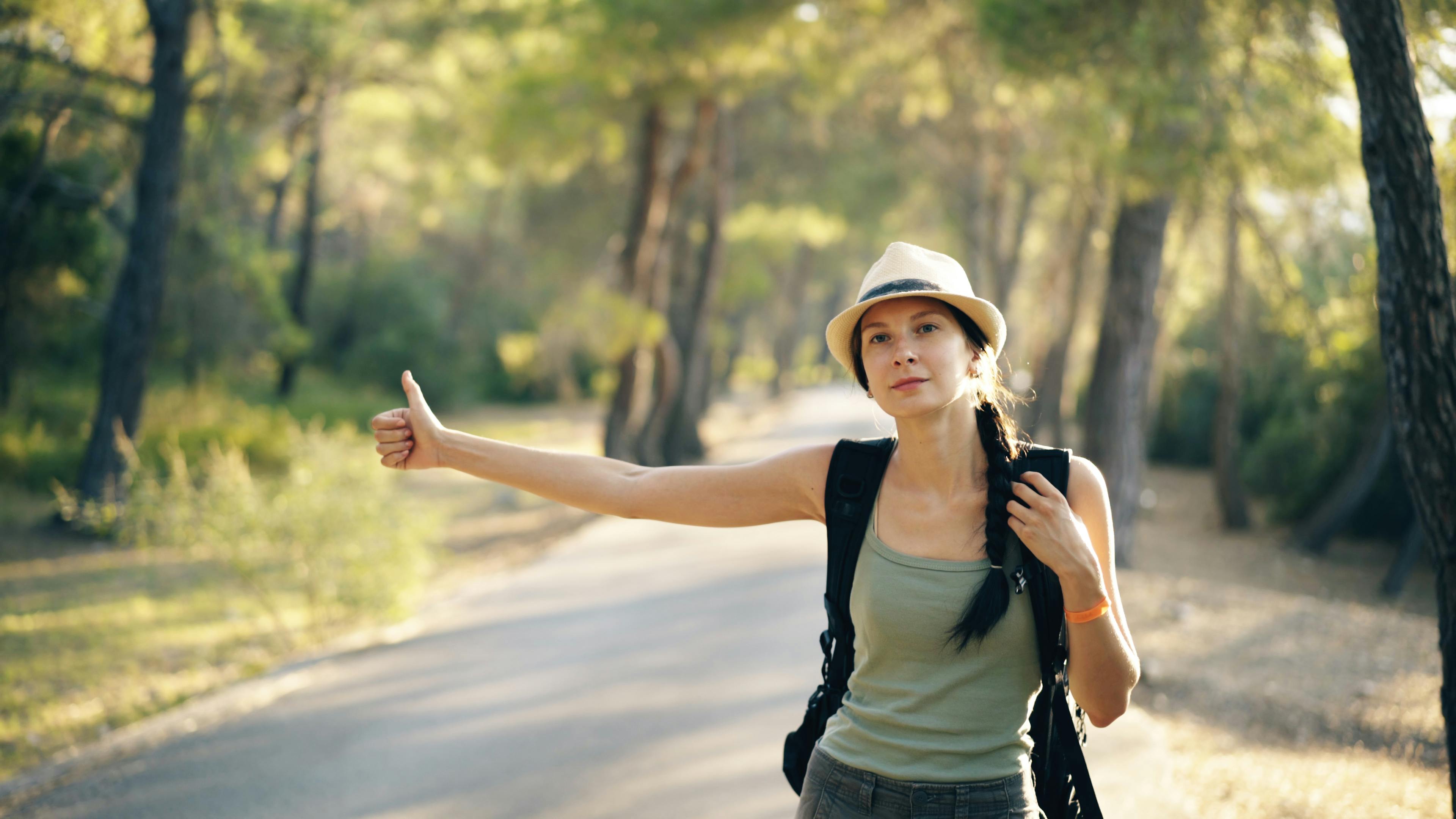 A woman hitchhiking | Source: Pexels