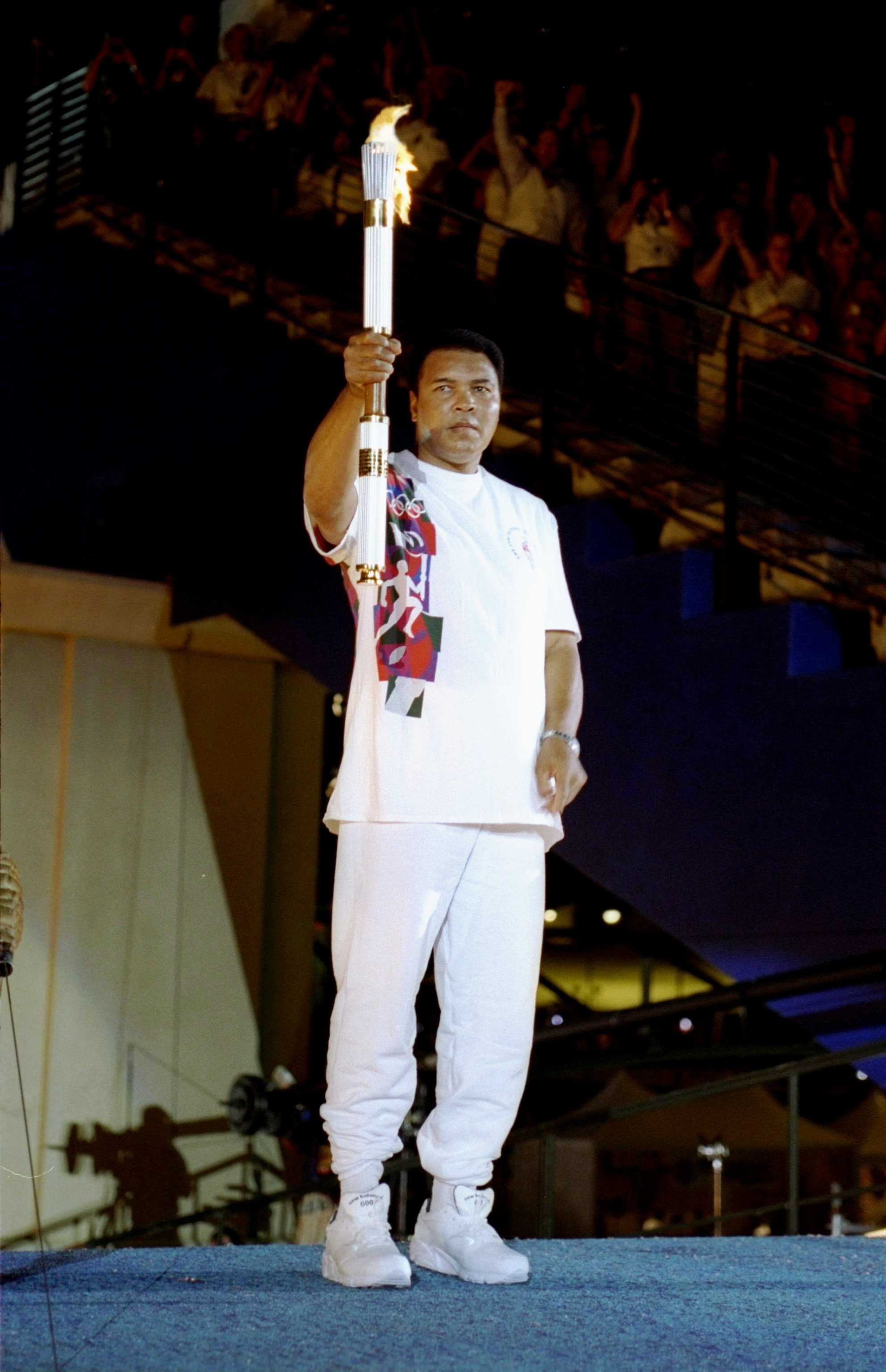 Muhammad Ali holds the torch on July 19, 1996, in Atlanta, Georgia. | Source: Getty Images