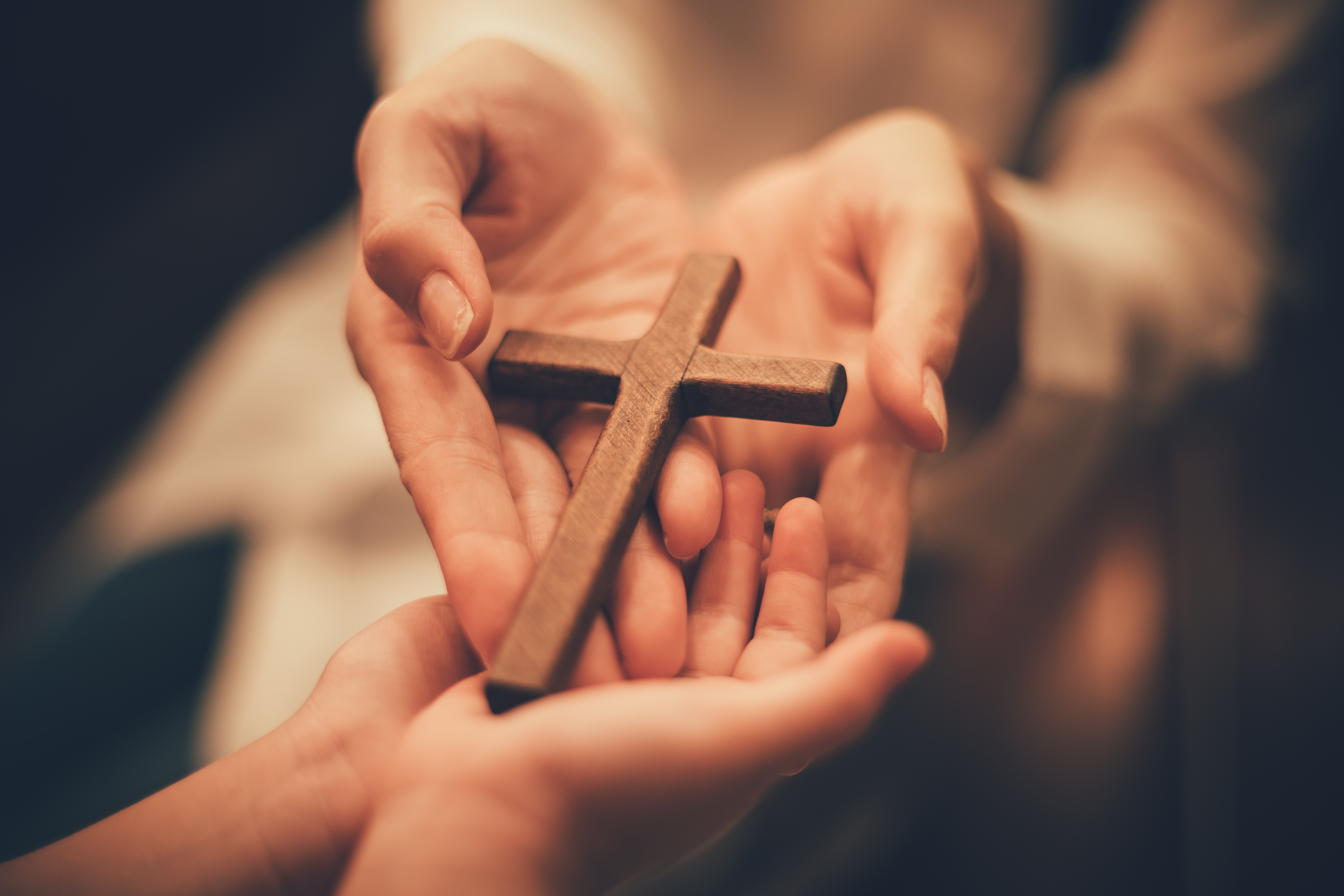 People holding a cross | Source: Shutterstock