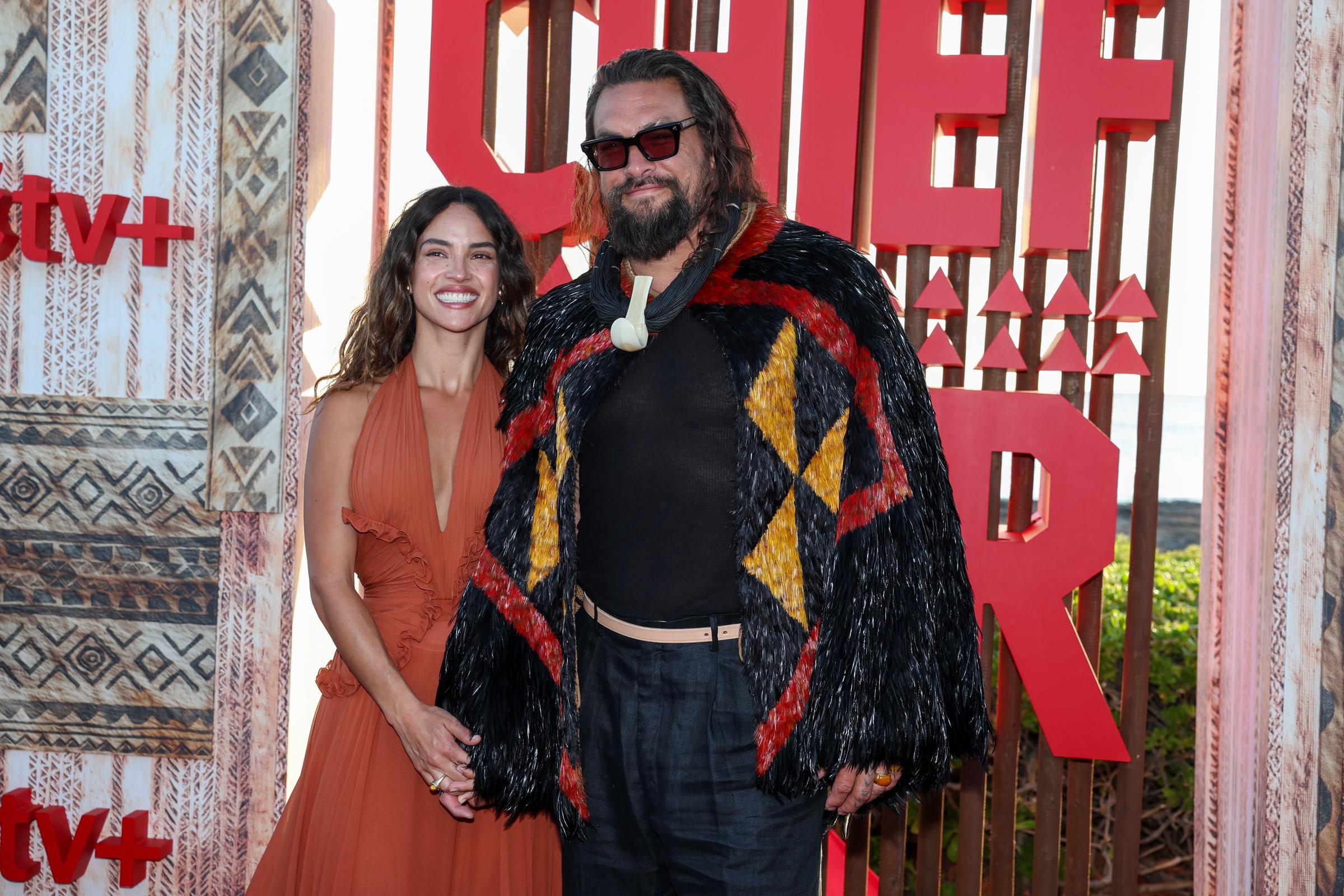 Adria Arjona and Jason Momoa are seen at the world premiere of the Apple TV+ series “Chief of War” at the Ko Olina Beach Park on July 18, 2025, in Kapolei, Hawaii. | Source: Getty Images