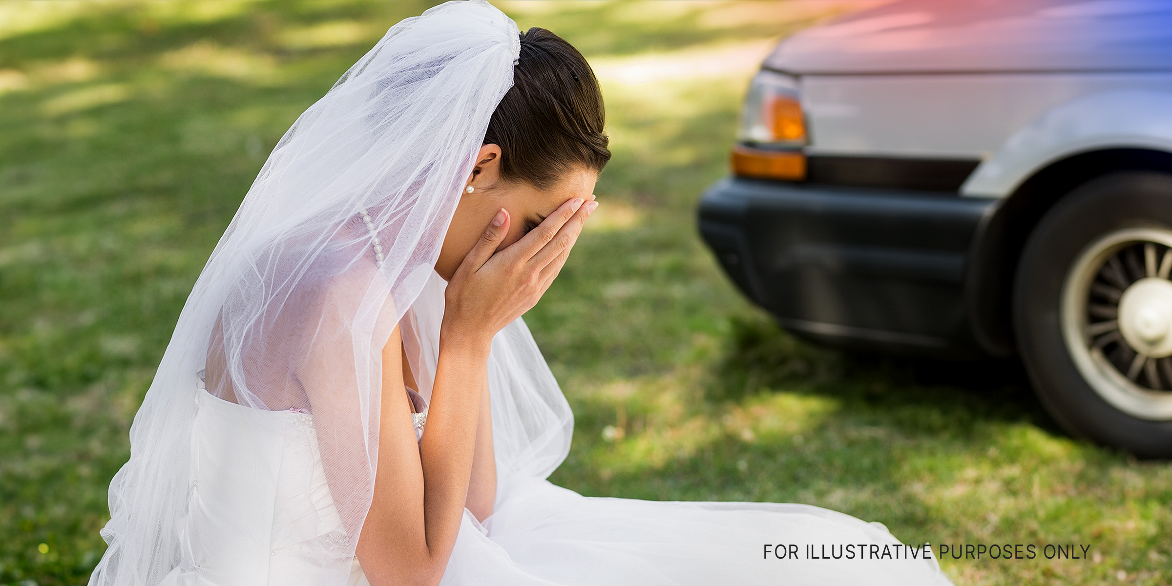 A bride sitting outdoors with her face buried in her hands | Source: Shutterstock