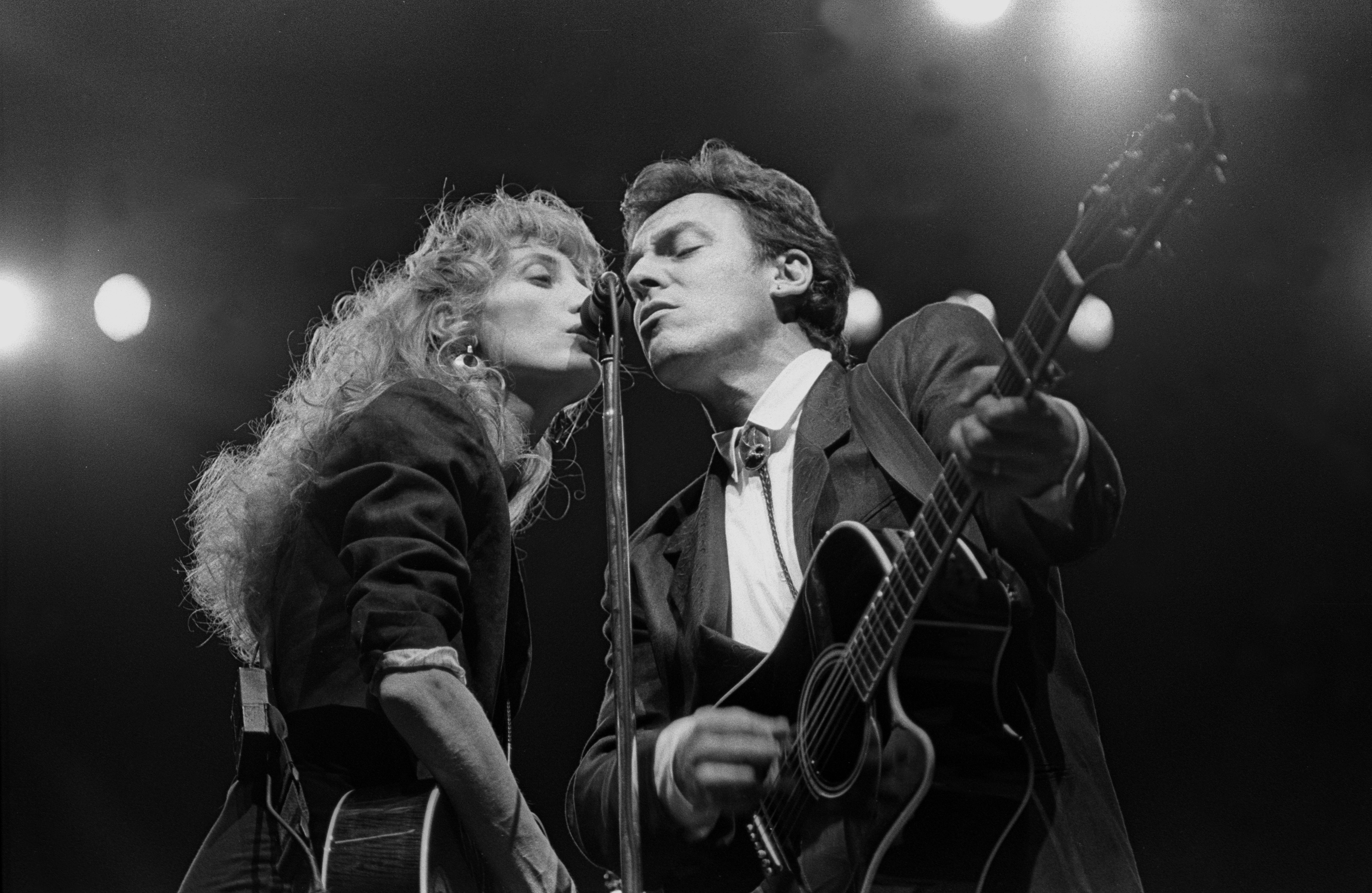 Patti Scialfa and Bruce Springsteen are shown performing  at a "live" concert appearance on February 28, 1988. | Source: Getty Images