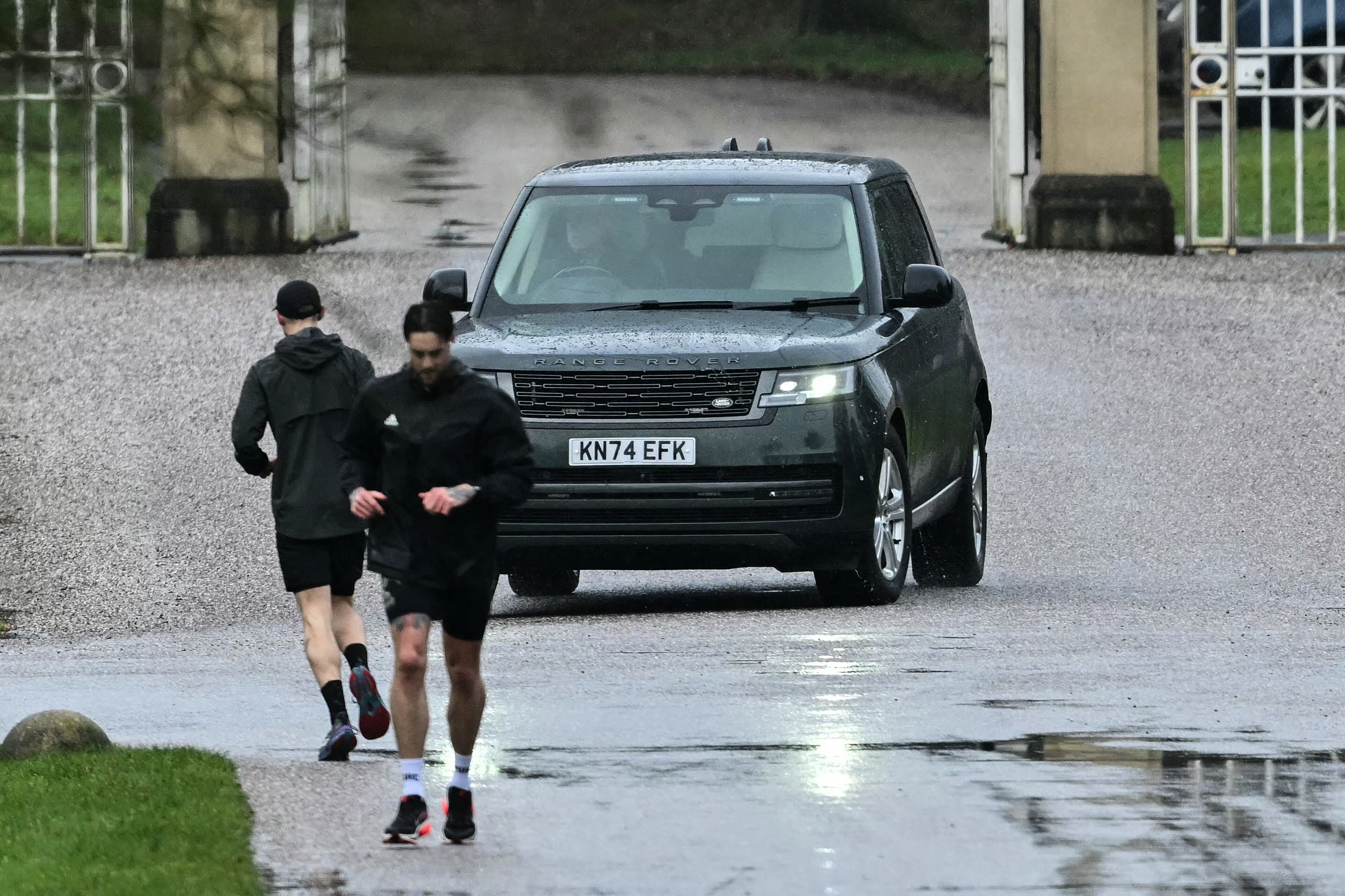 A car believed to be driven by Britain's former prince Andrew Mountbatten-Windsor leaves the entrance to the Royal Lodge, a 30-room property where he has lived since 2003, at Windsor Great Park on 1 February 2026 in Windsor, Berkshire. | Source: Getty Images