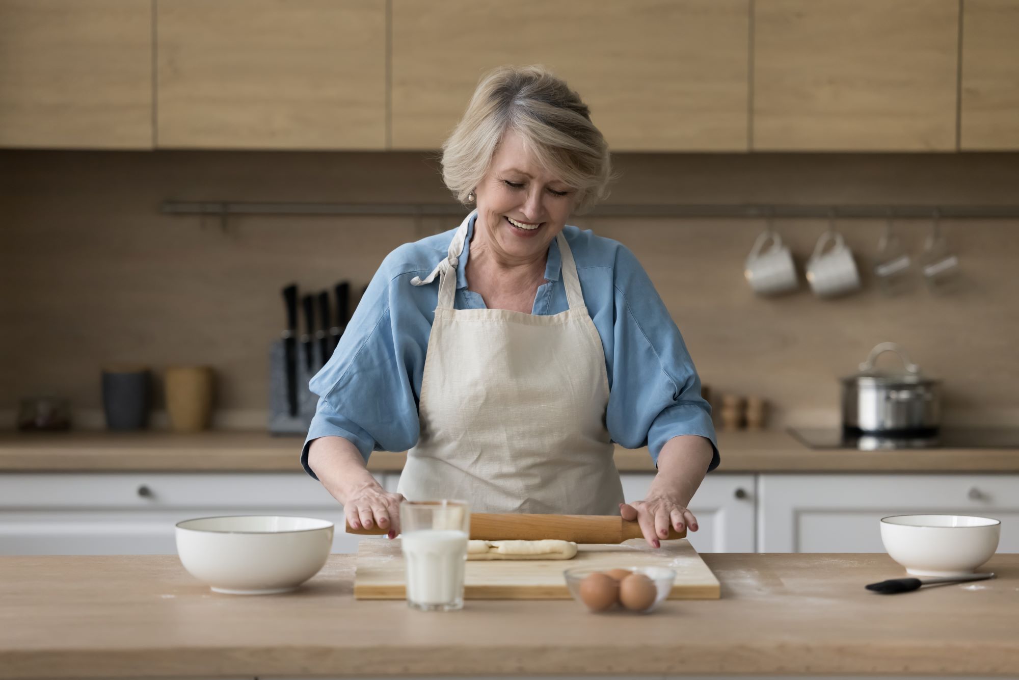 A woman rolling dough.┃Source: Shutterstock
